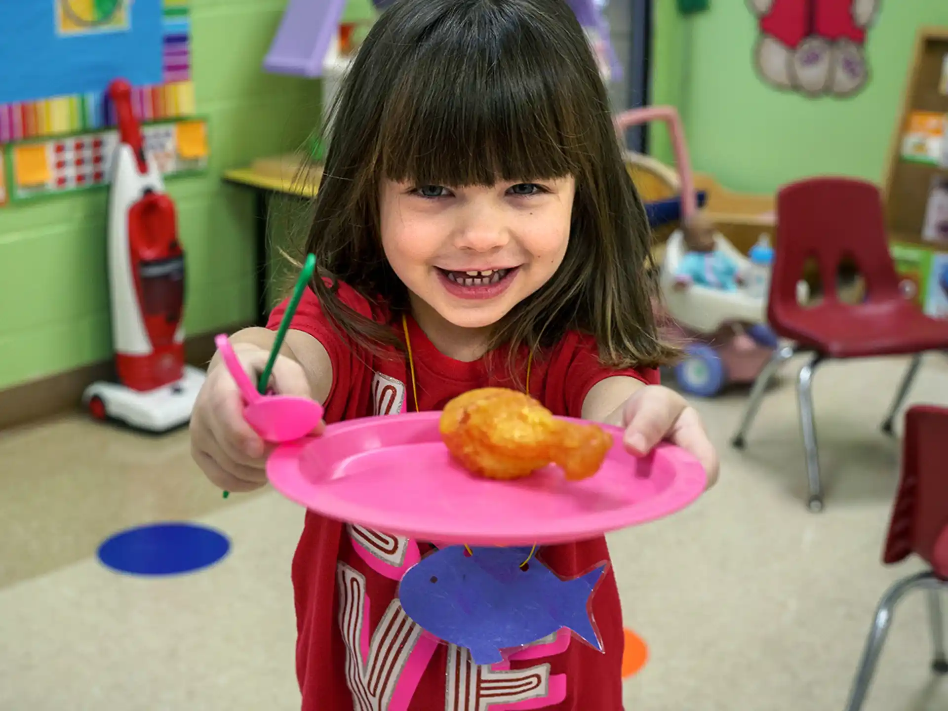 a girl holding a plate of food