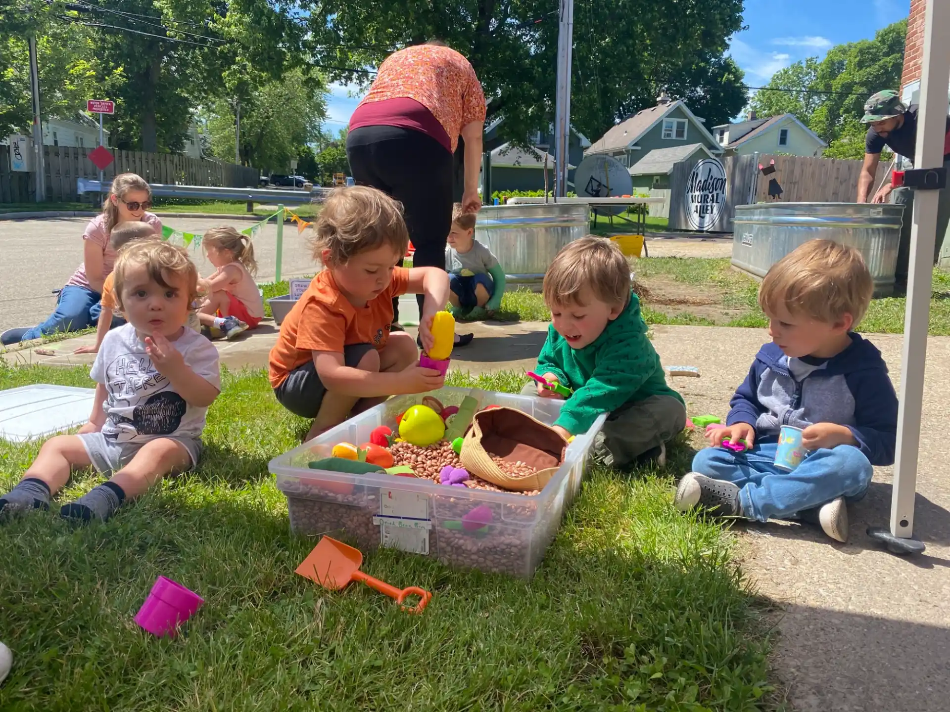 a group of children playing in the grass