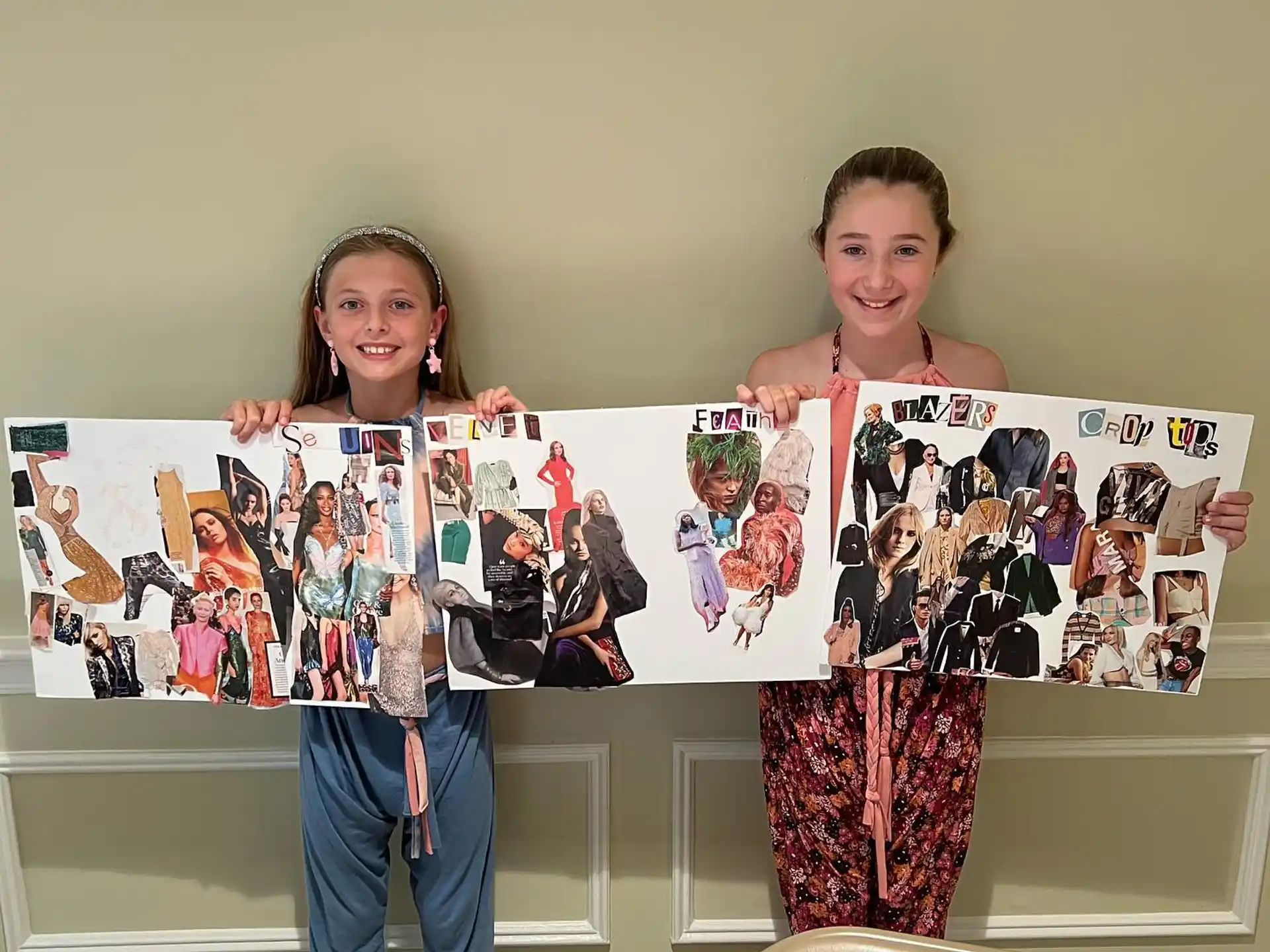 a boy and girl holding up a picture of a person