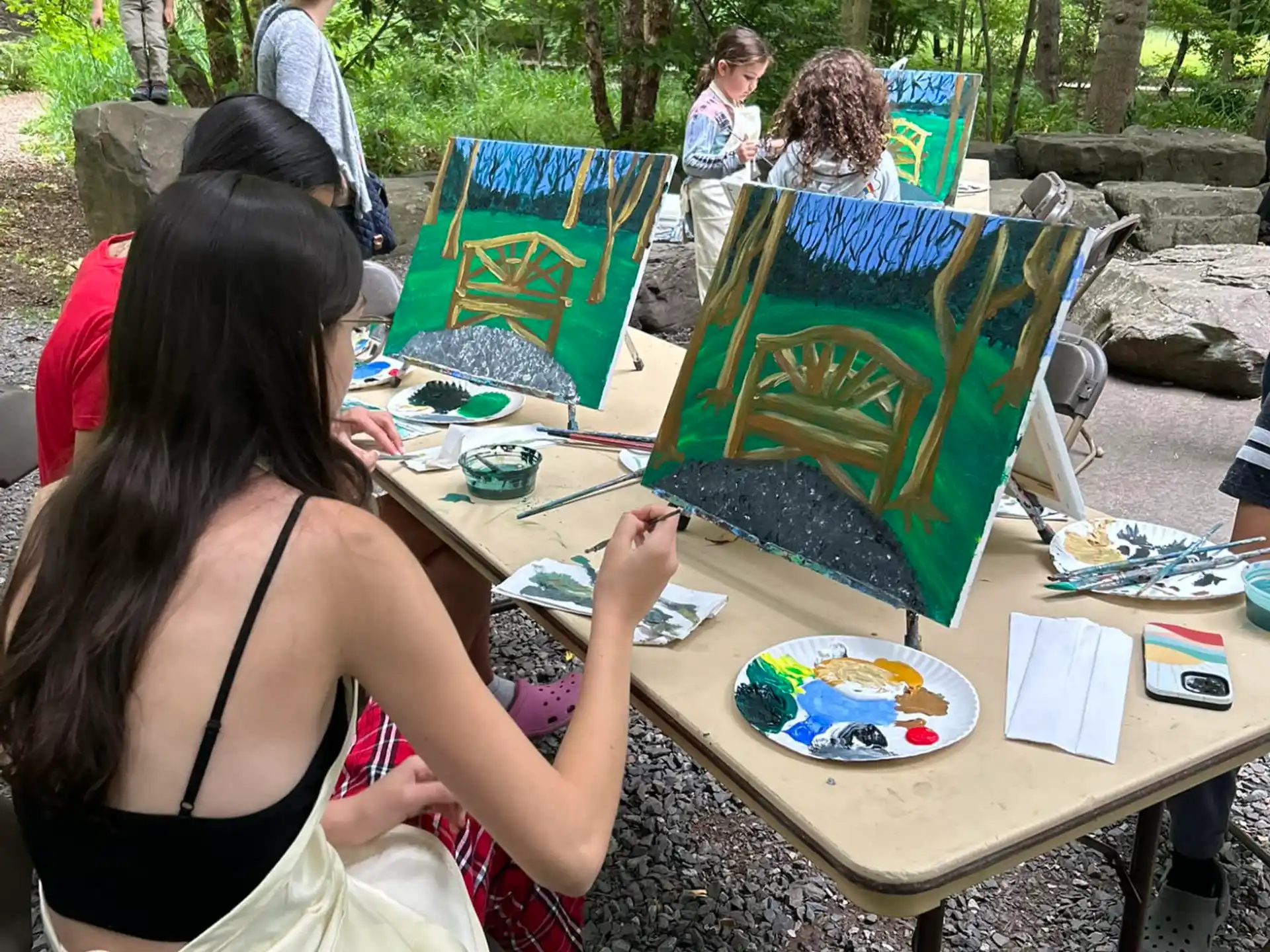 a group of people sitting at a table outside