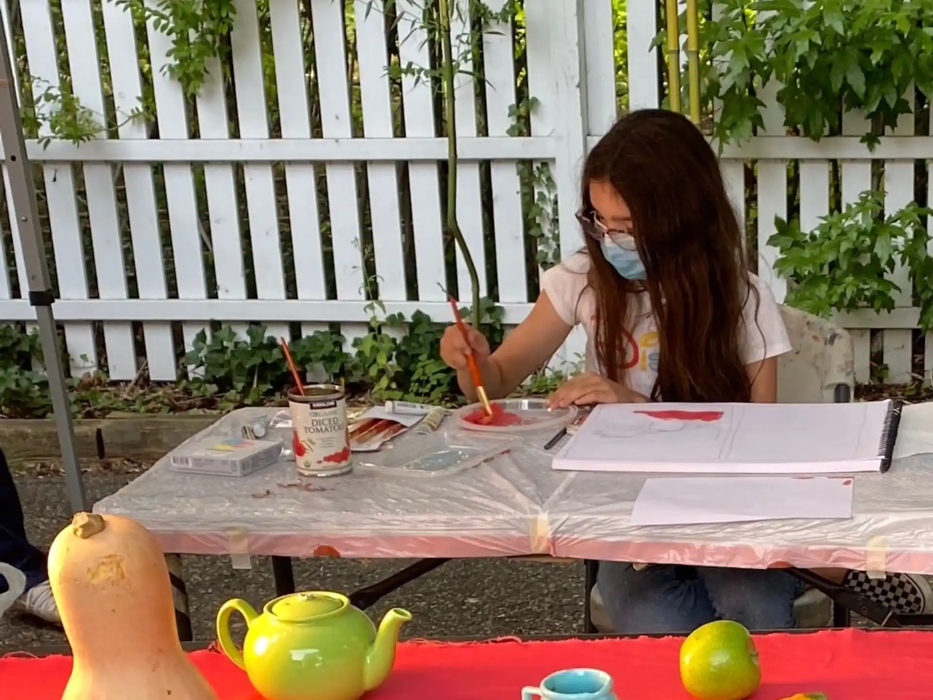a woman sitting at a table with a phone to her ear