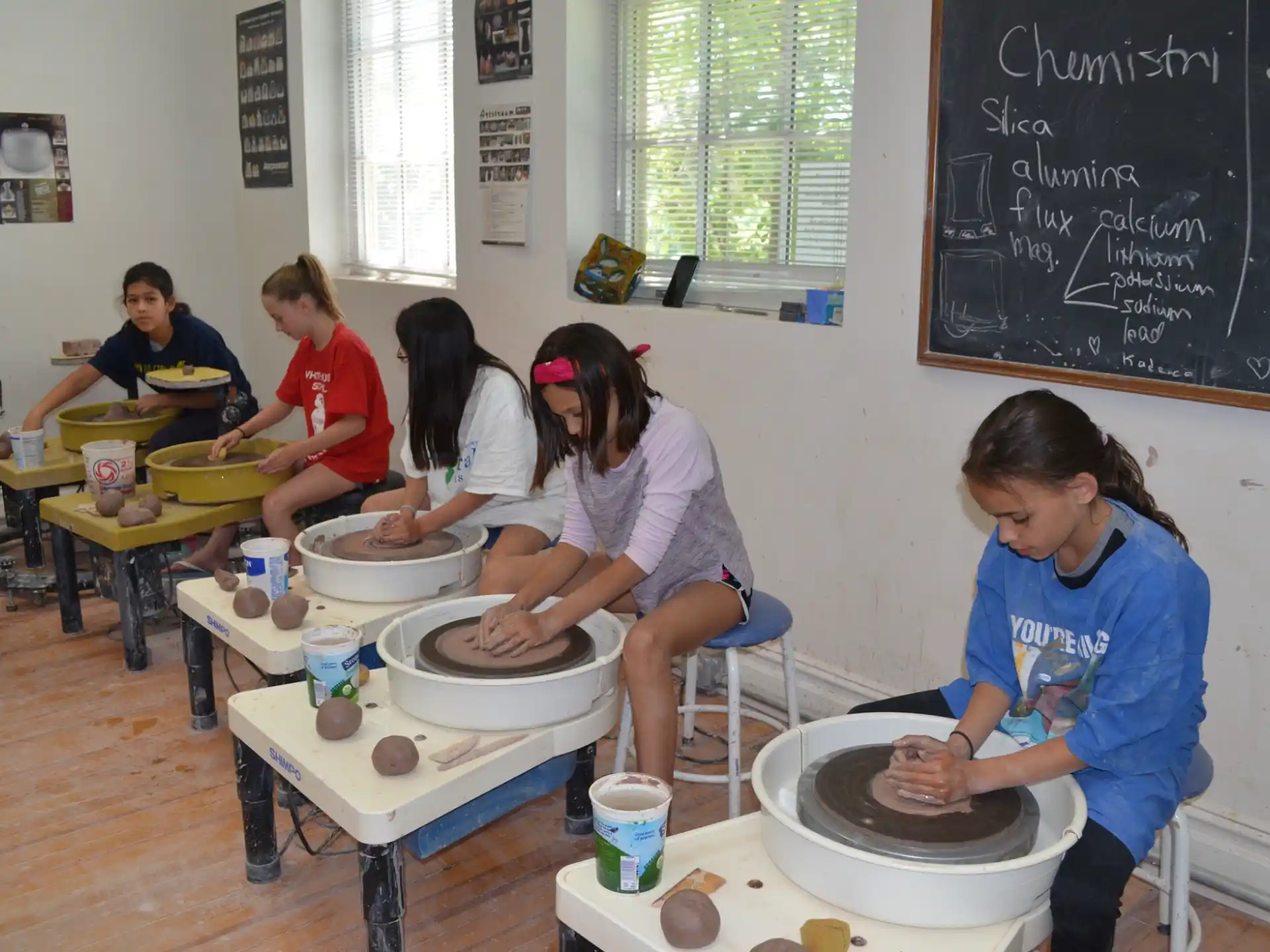 a group of people sitting at a table with food on it