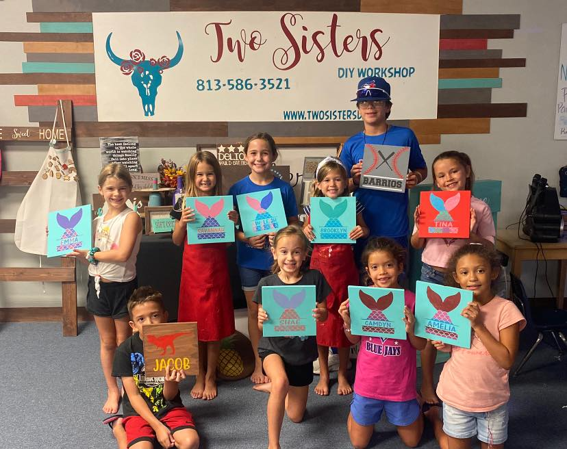 a group of children holding up books
