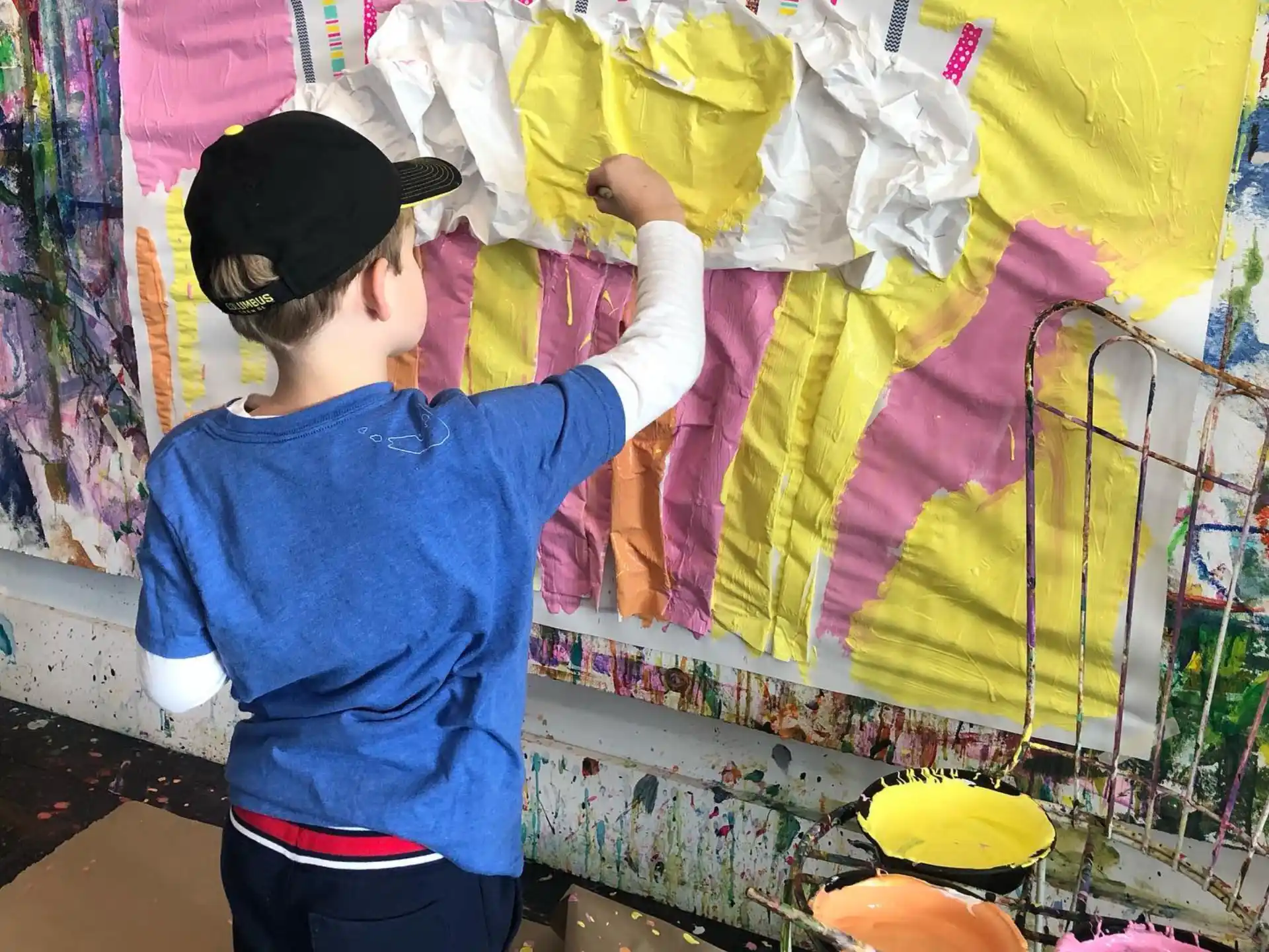 a child holding a yellow bag