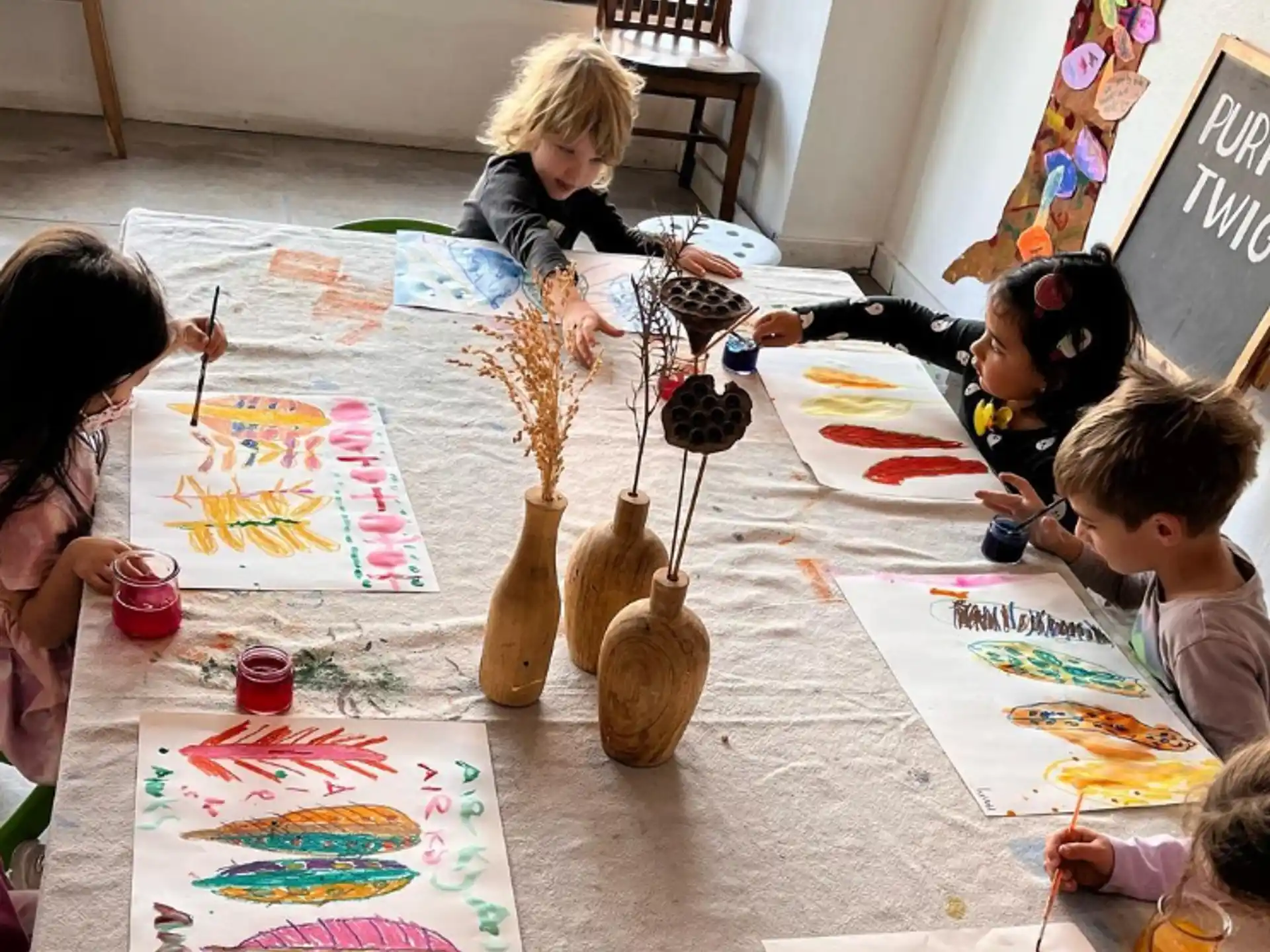 a group of children sitting around a table playing a board game