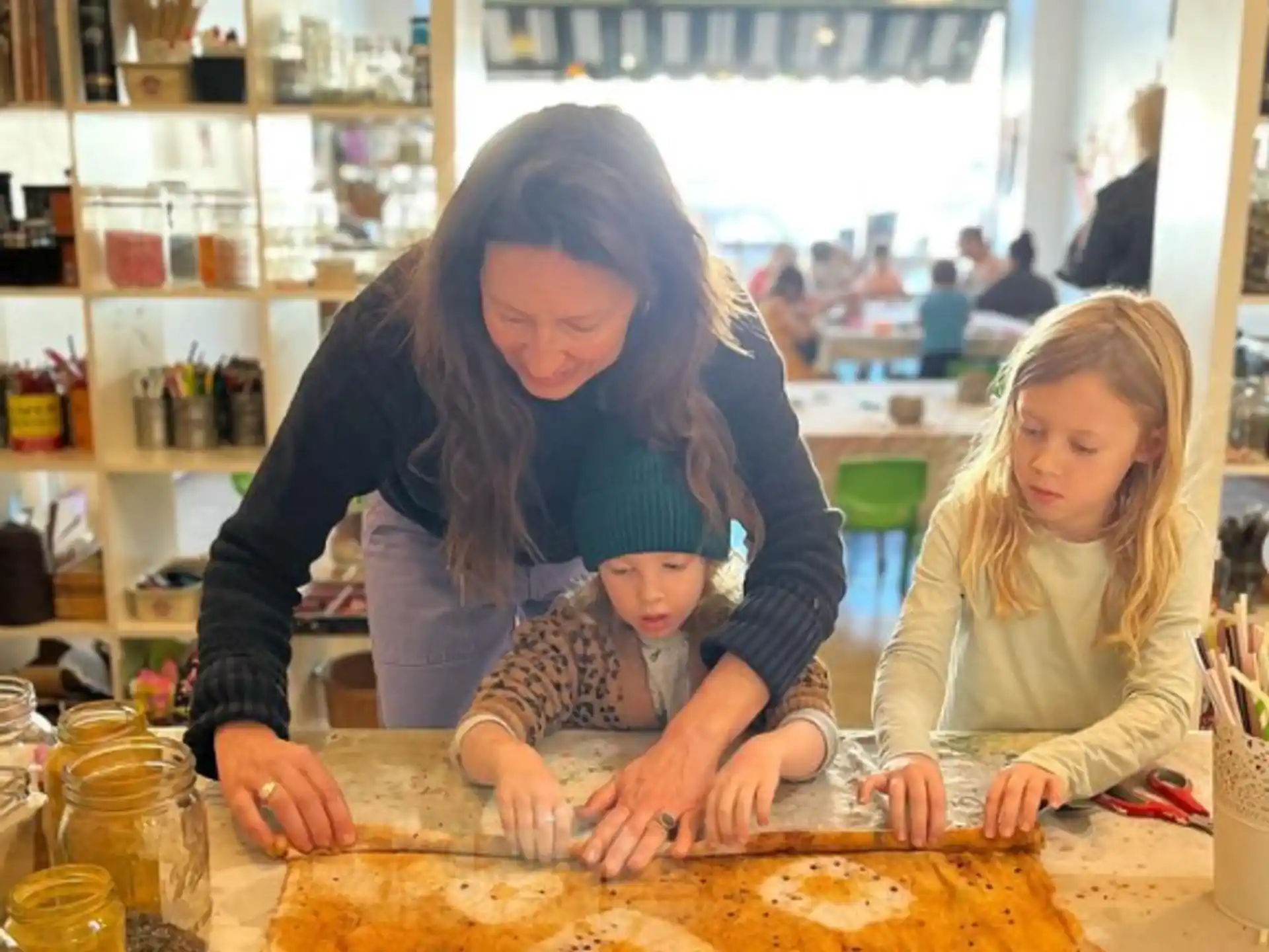 a woman and a child making a cake