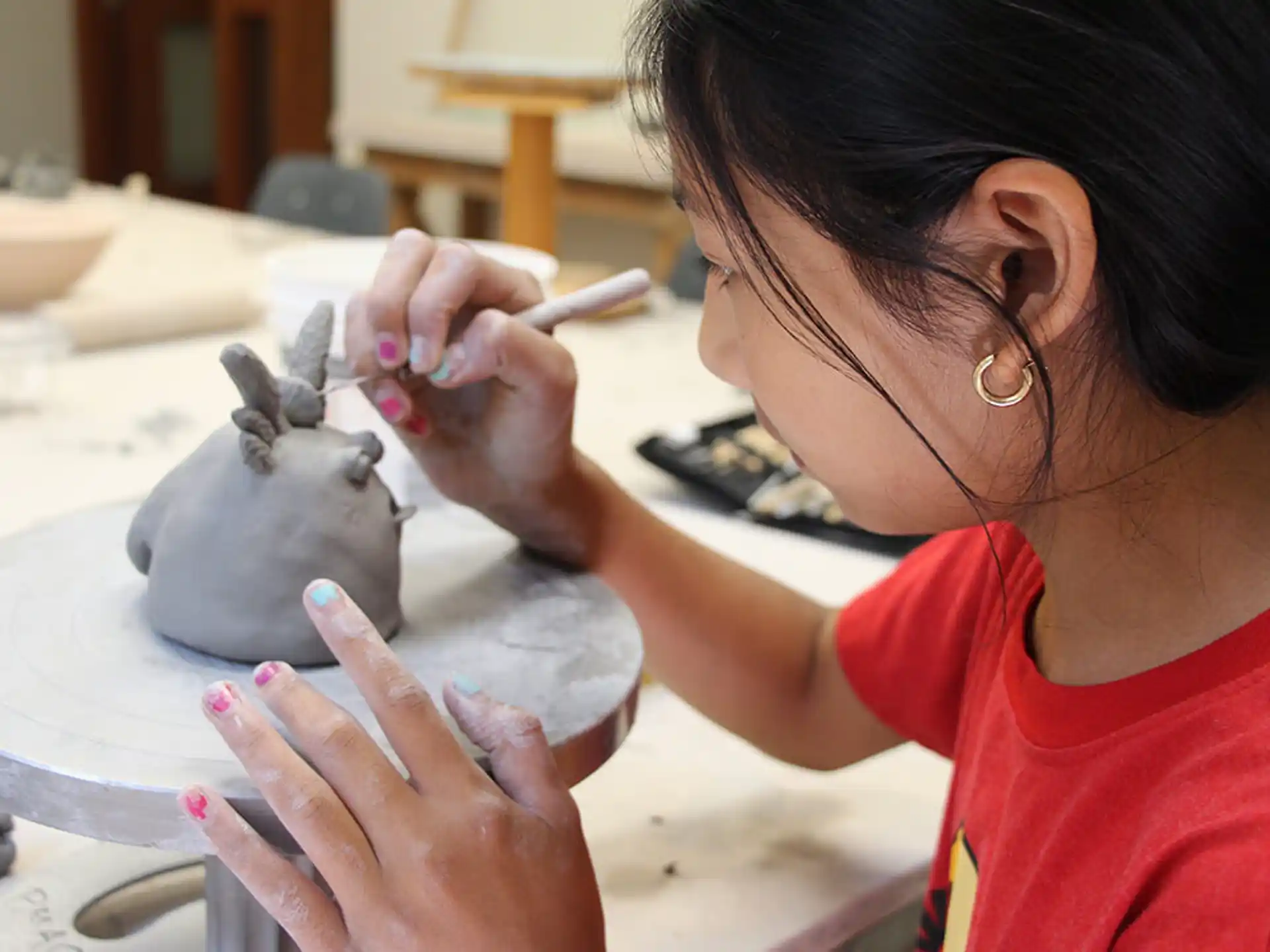 a person painting a clay