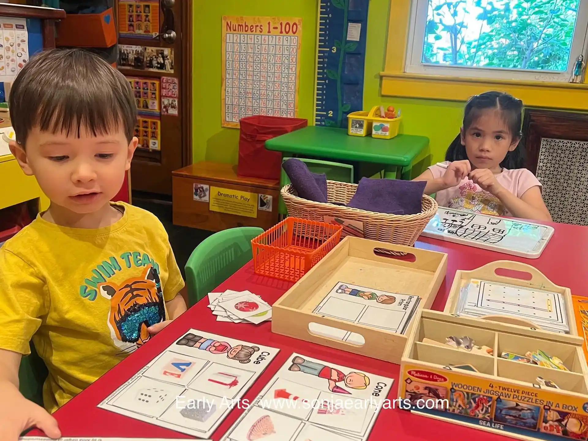 children sitting at a table with books