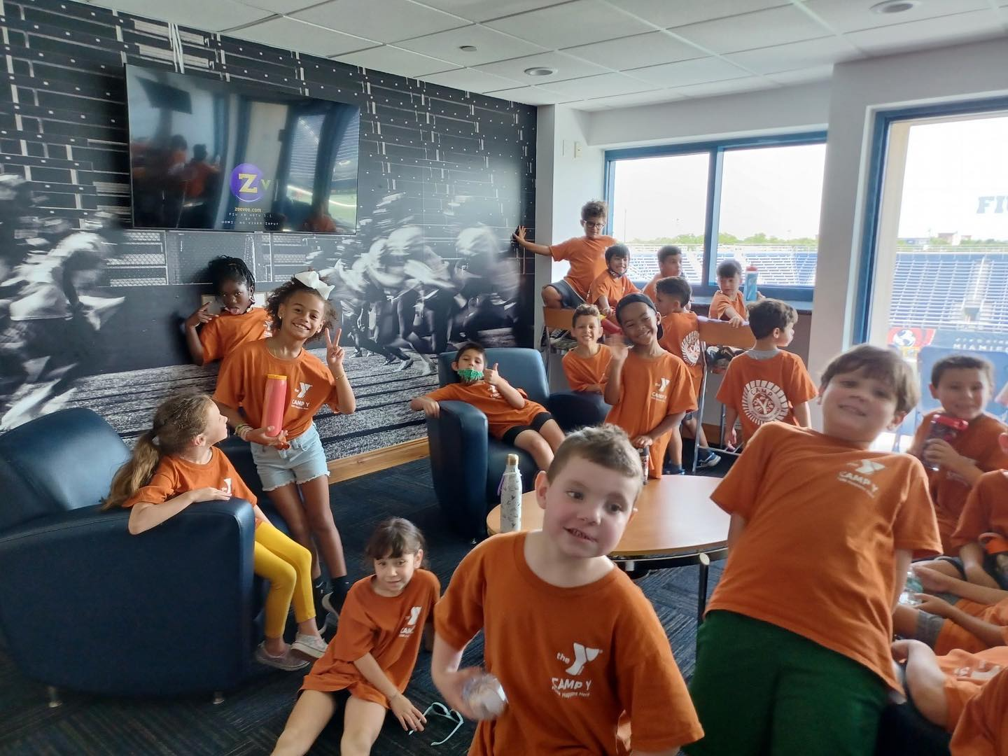 a group of children in orange shirts