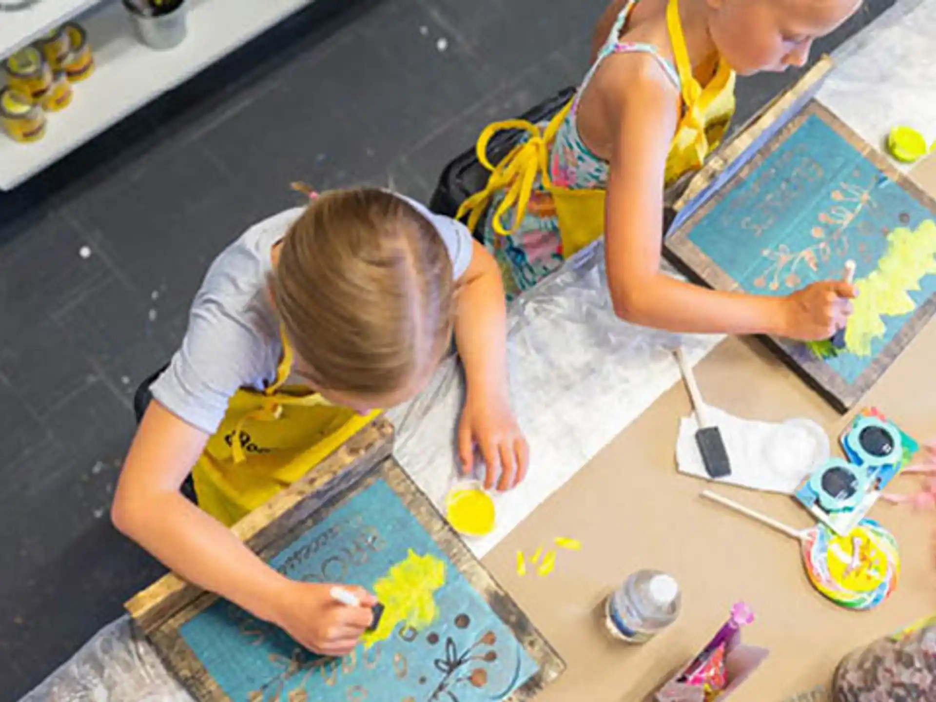 a child painting on a table