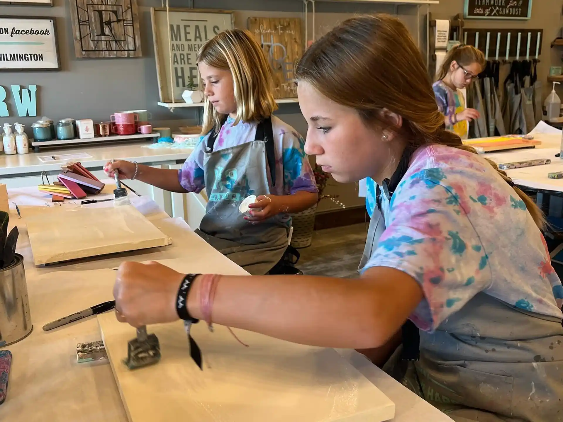 a person showing a young girl something on a paper