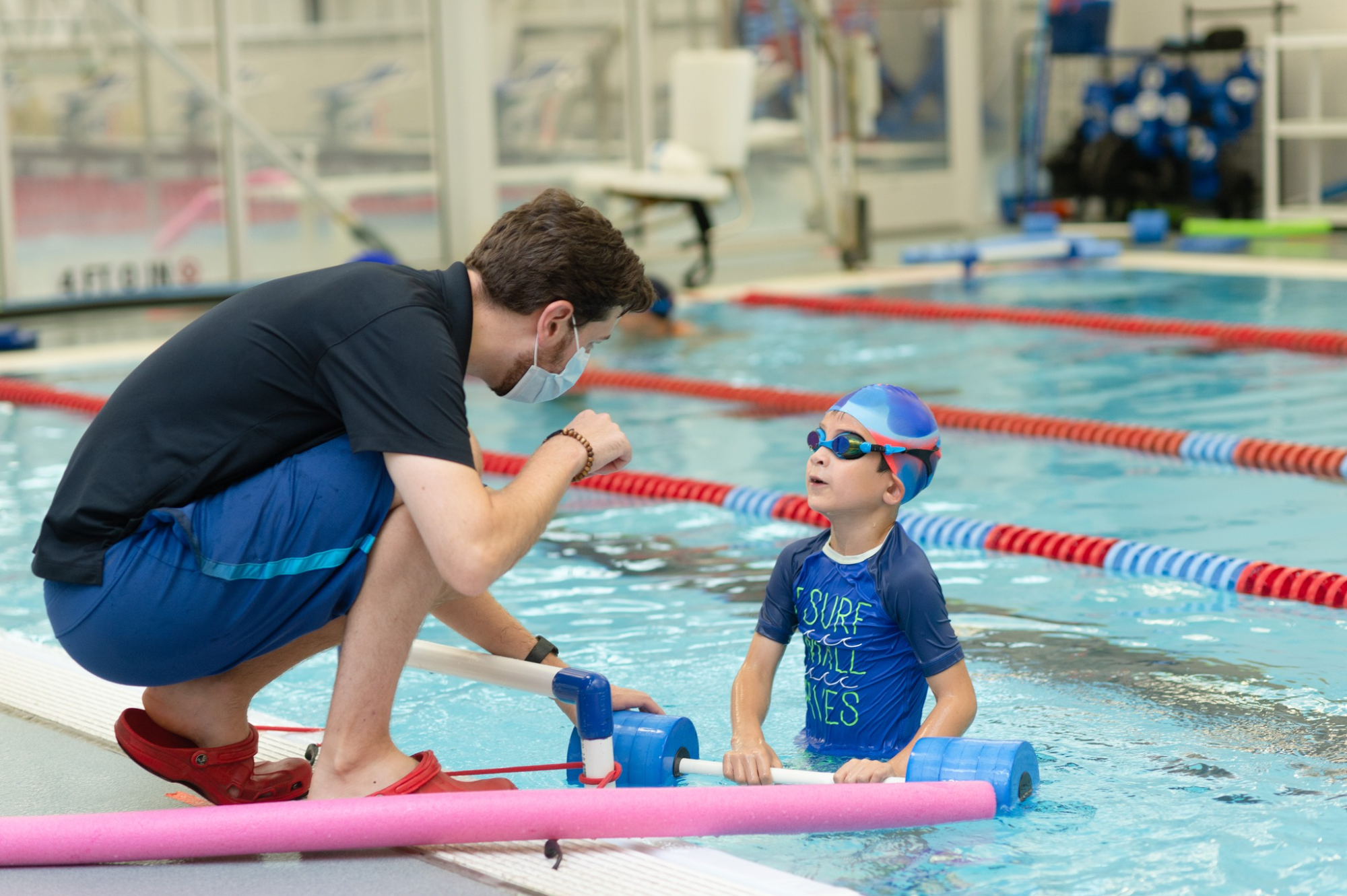 a man and a child in a pool