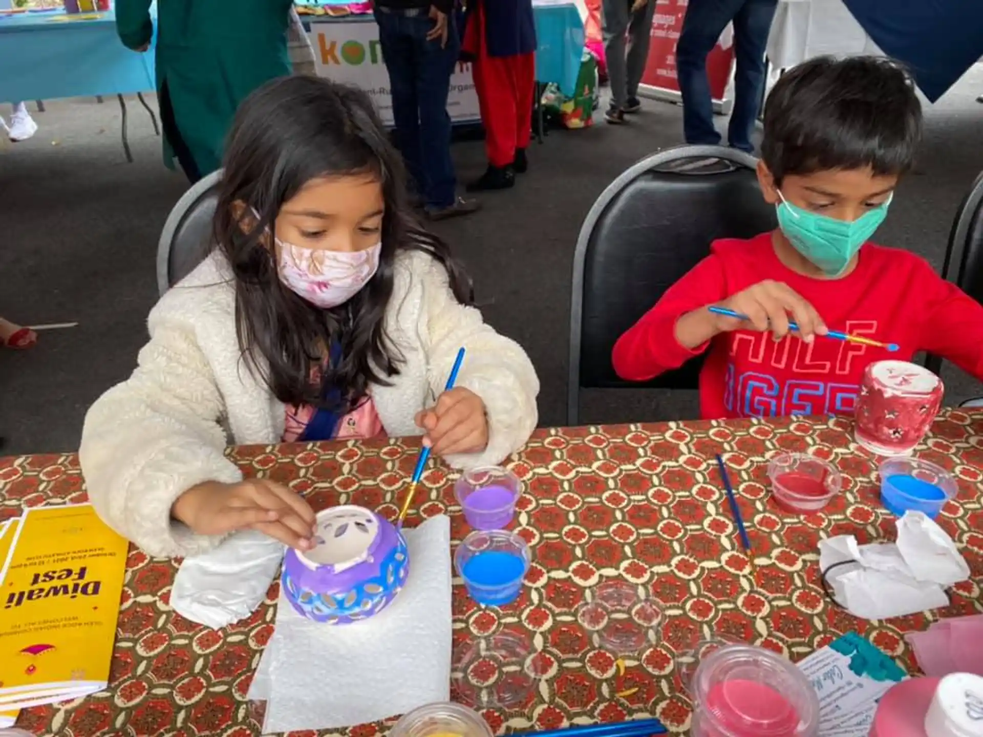 a couple of children painting