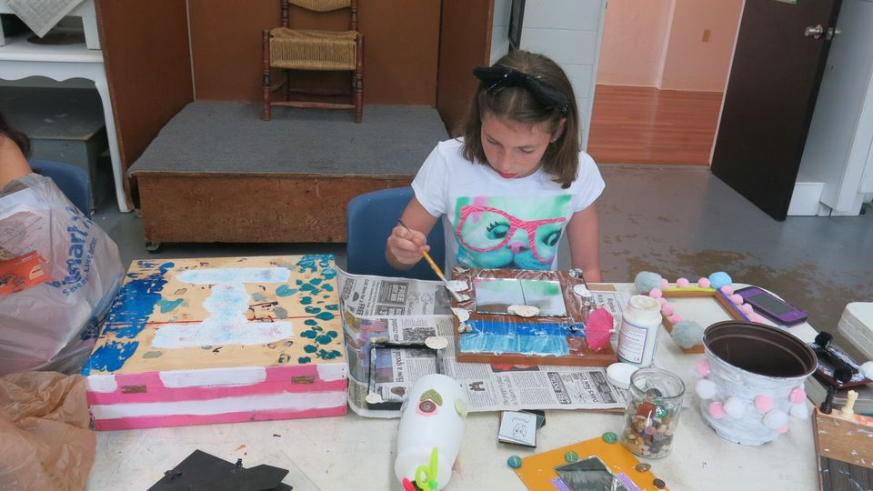 a girl painting on a table
