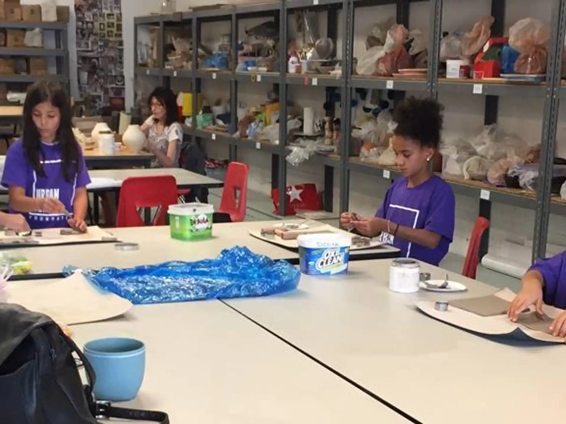 a person and several children sitting at a table