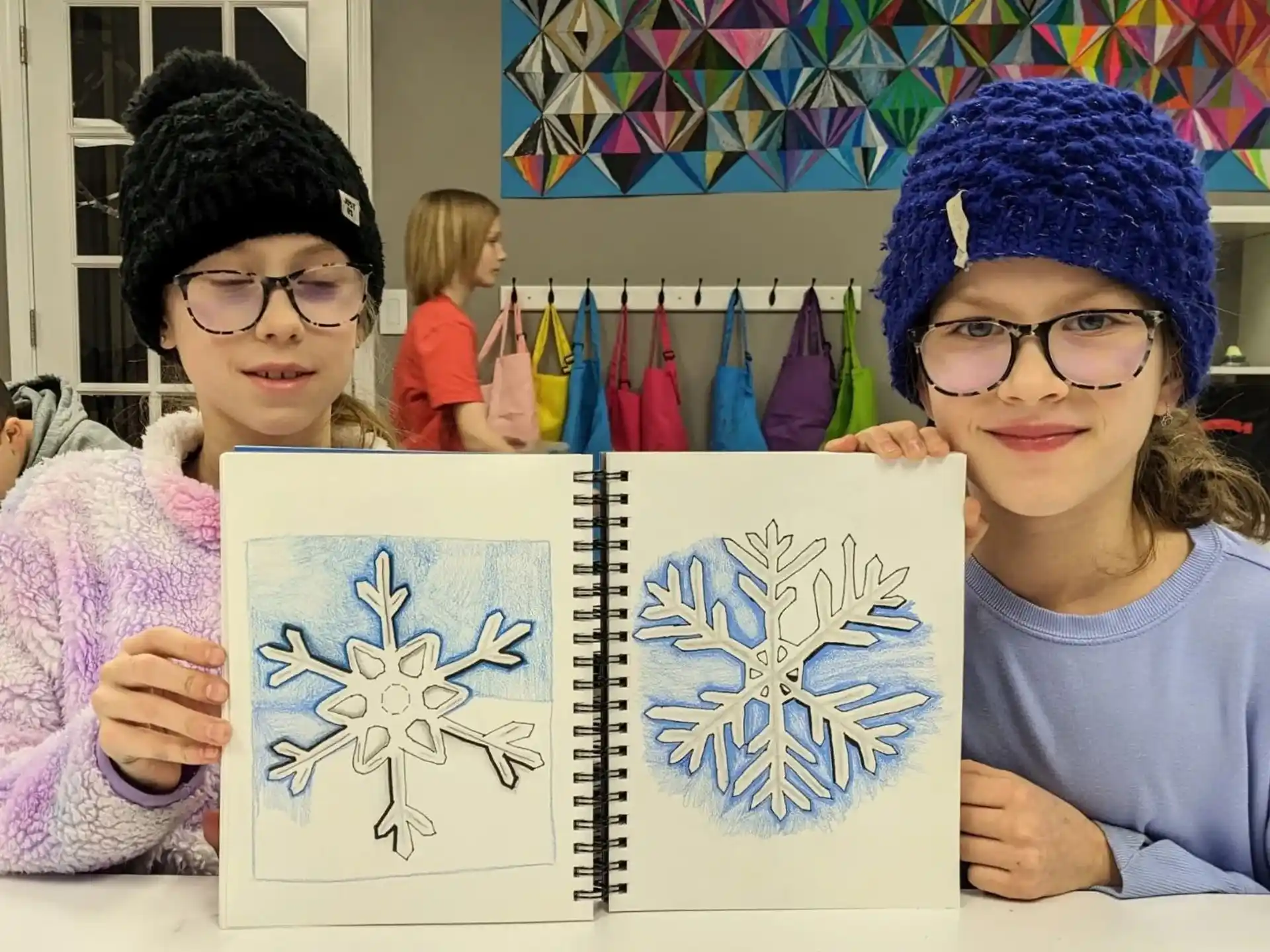 a couple of kids holding a drawing