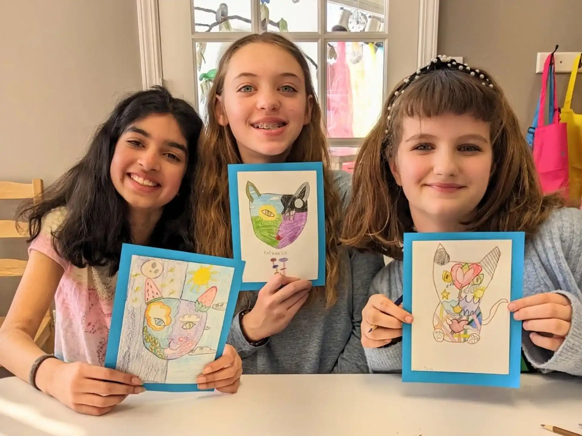 a group of girls holding up books
