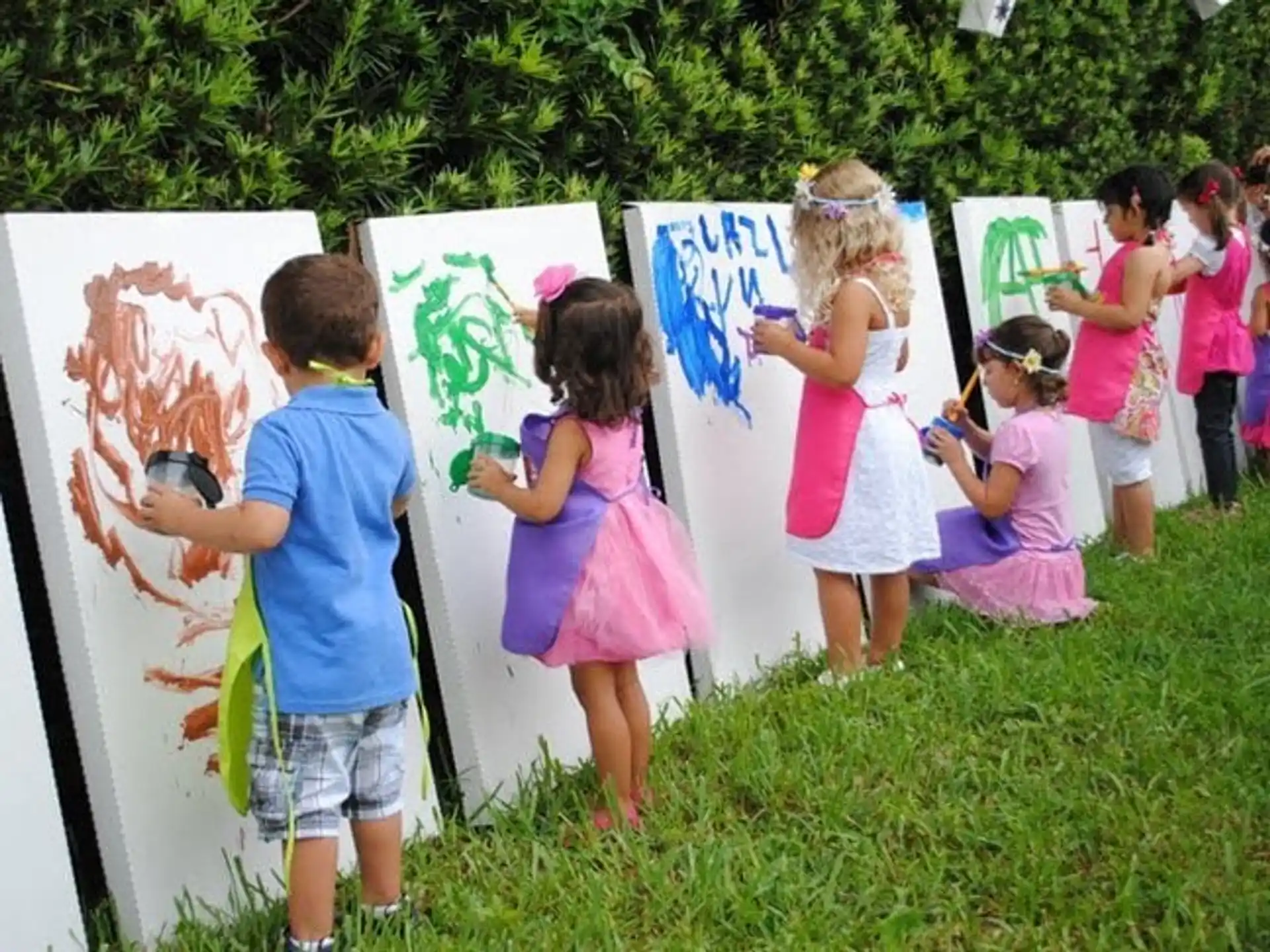 children painting on a canvas
