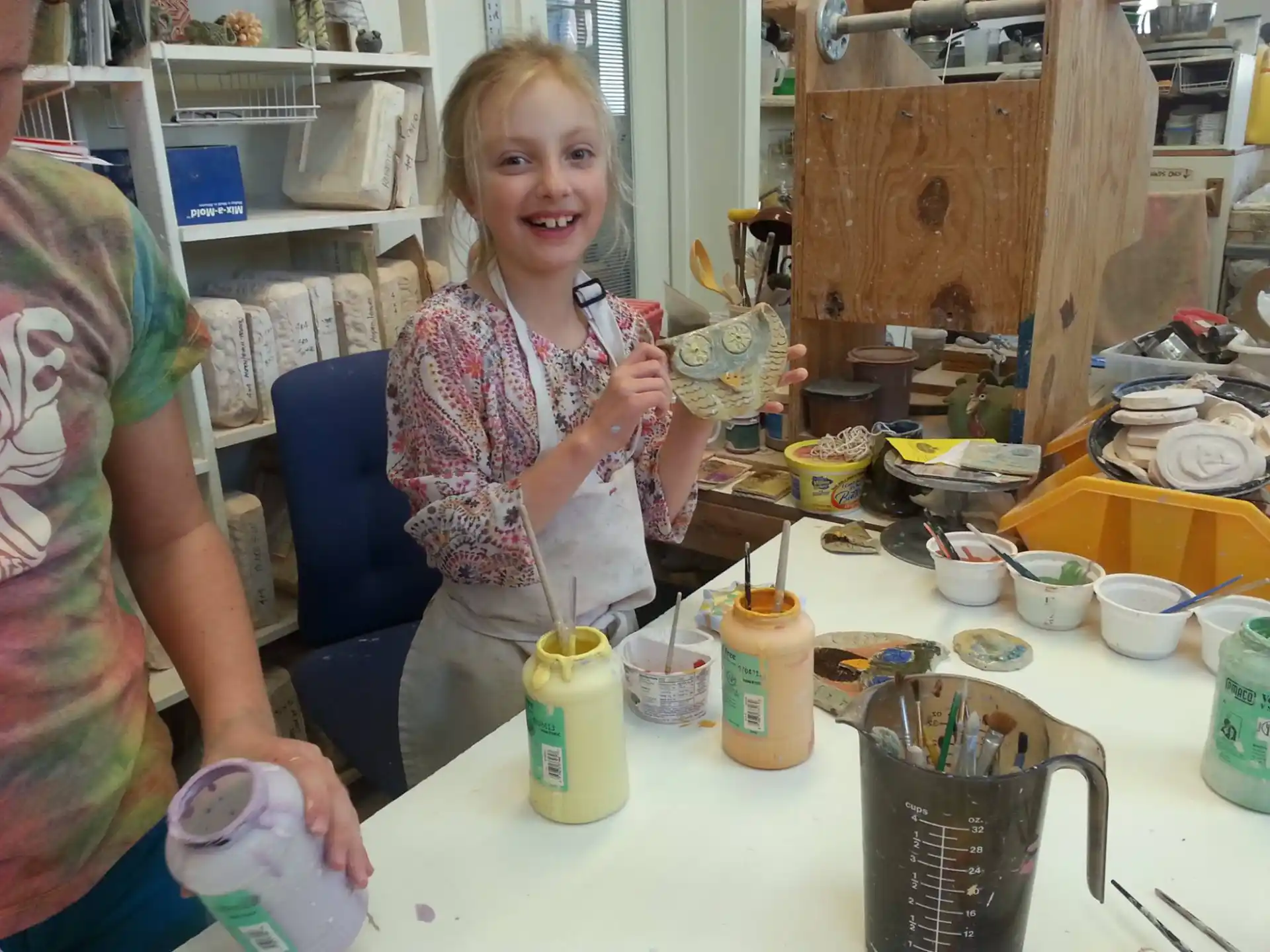 a woman pouring a liquid into a glass