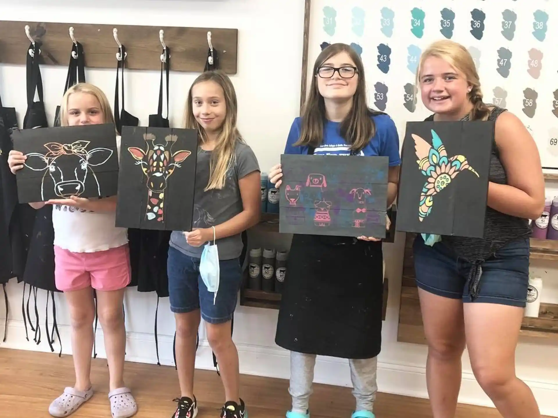 a group of girls holding up a sign
