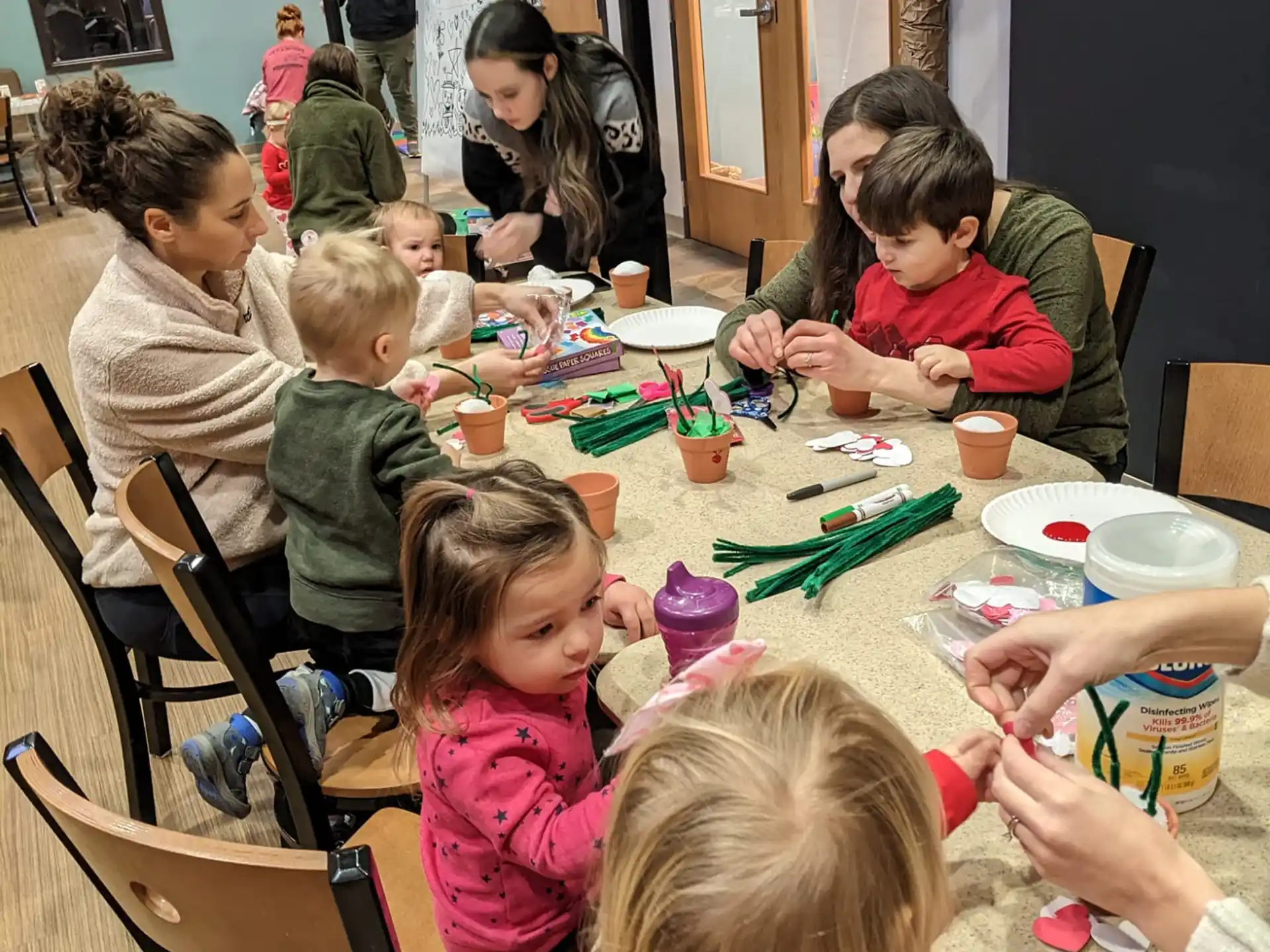 a group of children sitting around a table
