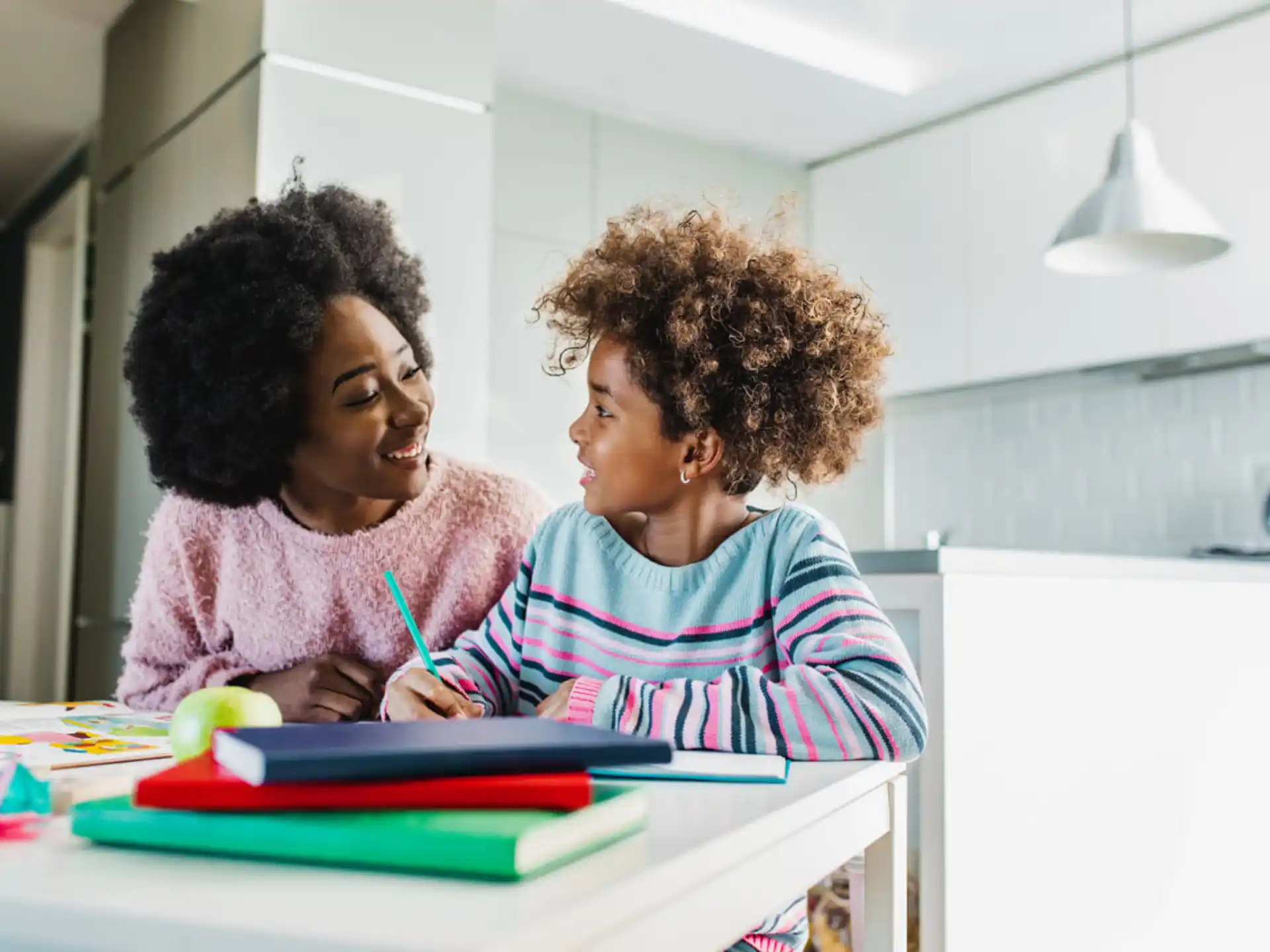 a person and a child looking at a book