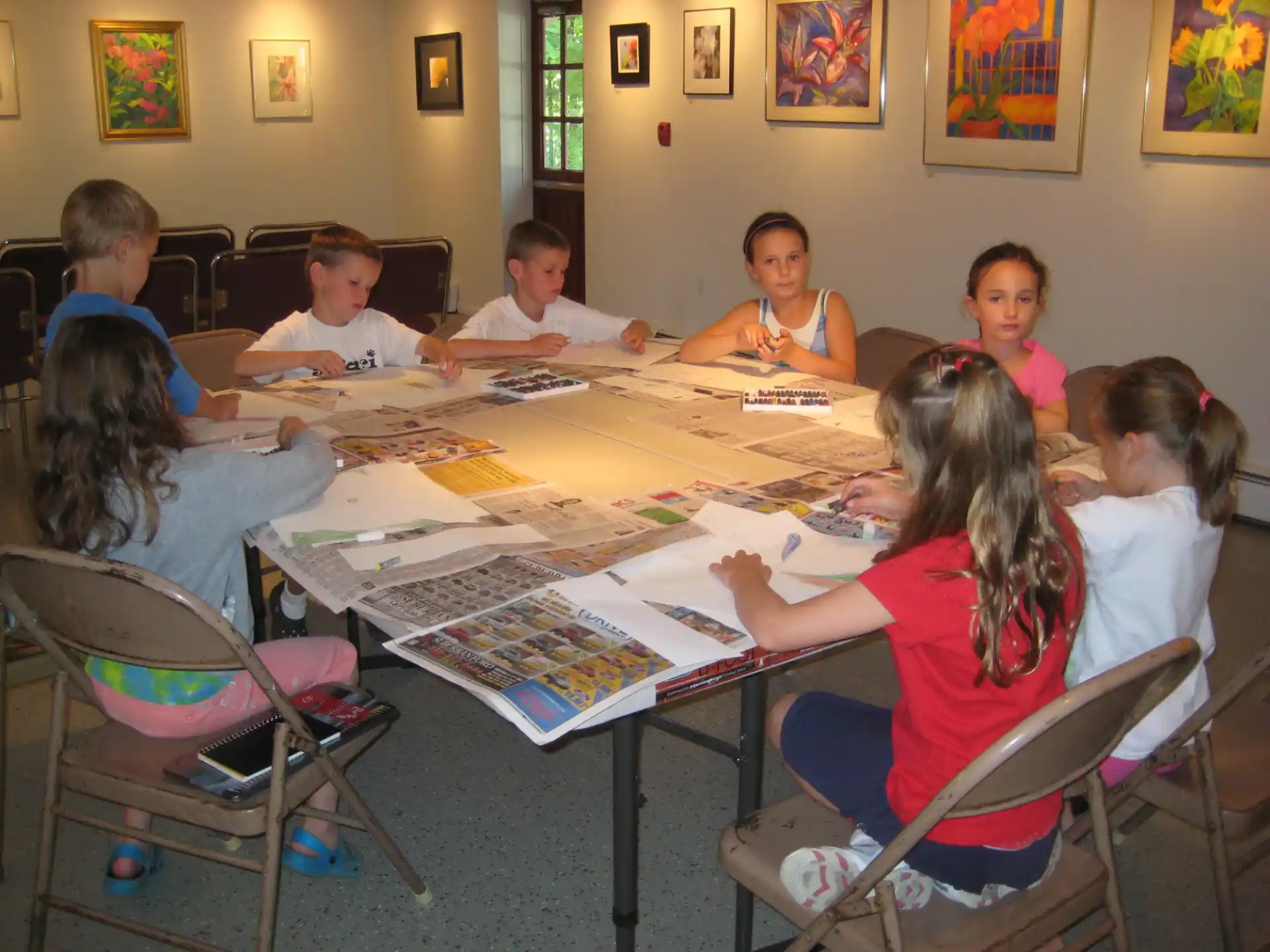 a group of children sitting around a table