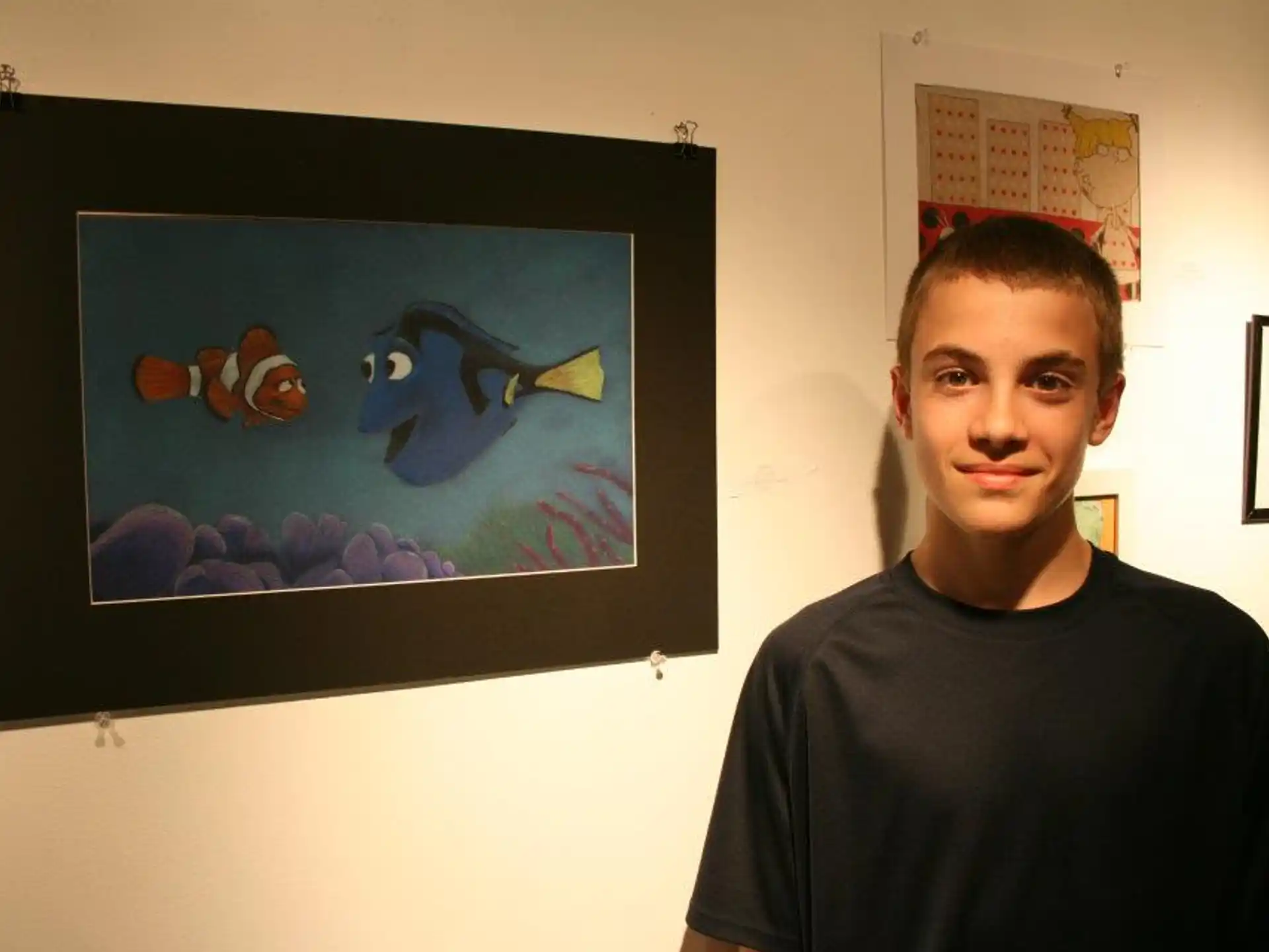a man standing in front of a framed picture