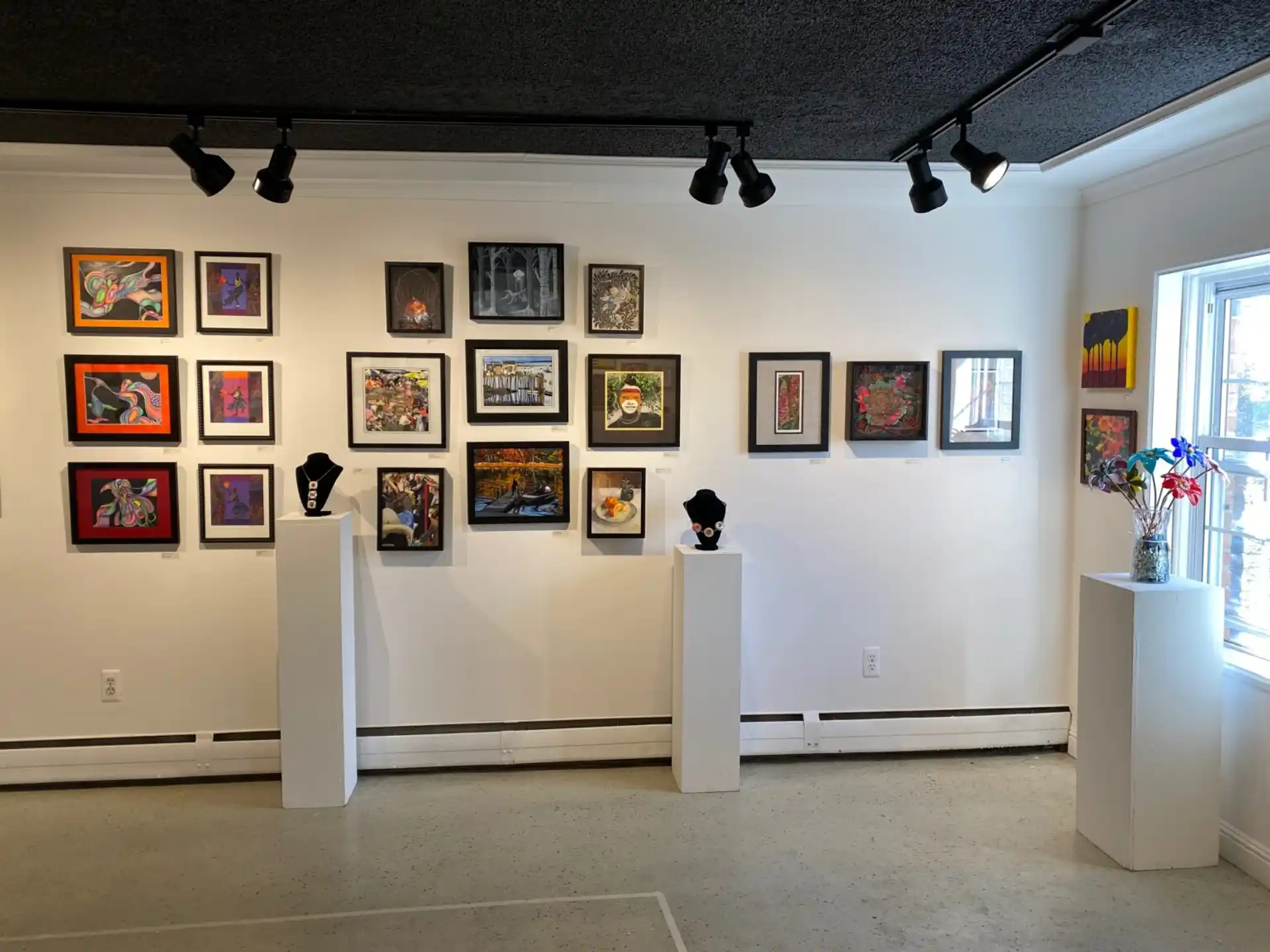 a room with a wall of art