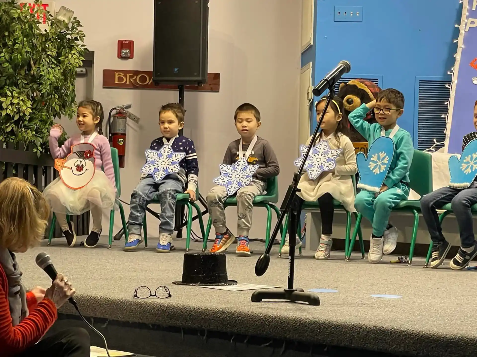 a group of kids sitting on a bench with instruments