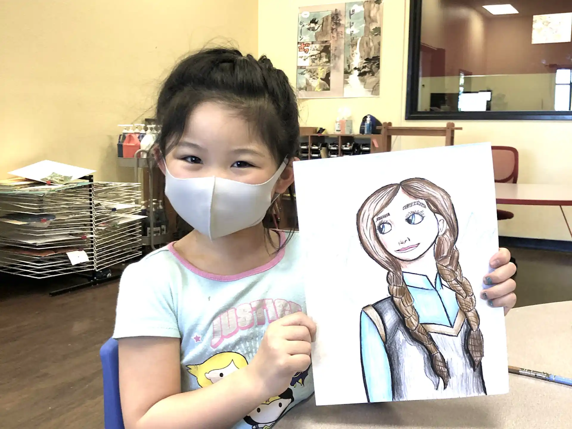 a girl holding a drawing