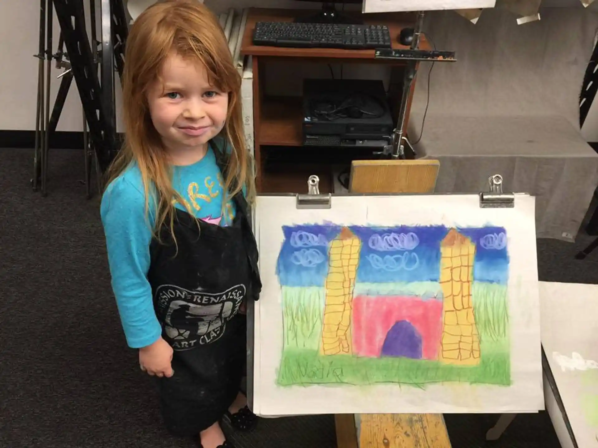 a girl holding a painting