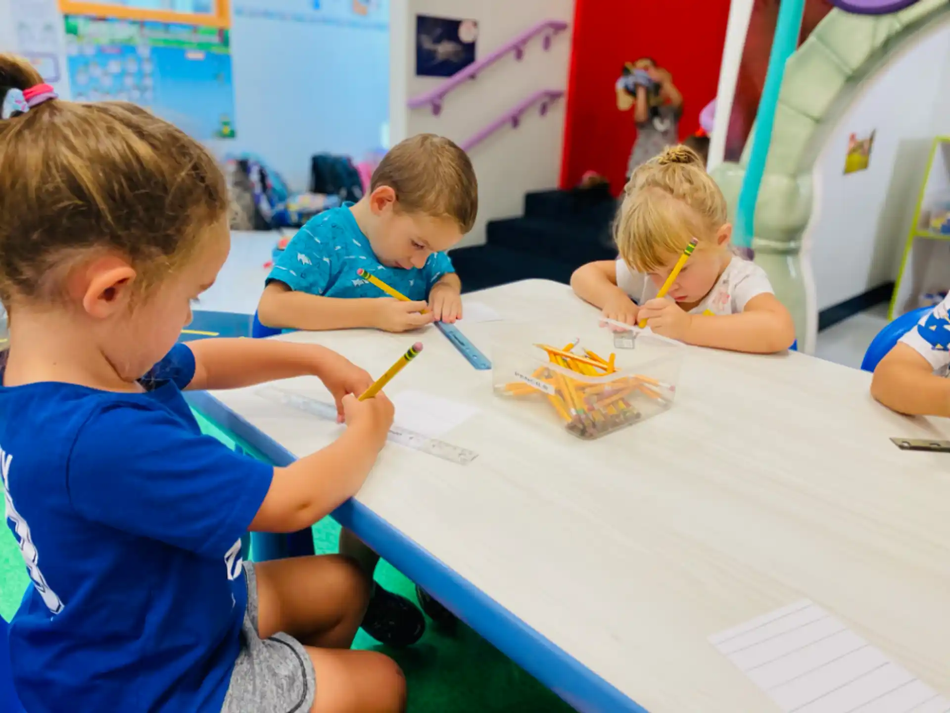 a group of children sitting at a table