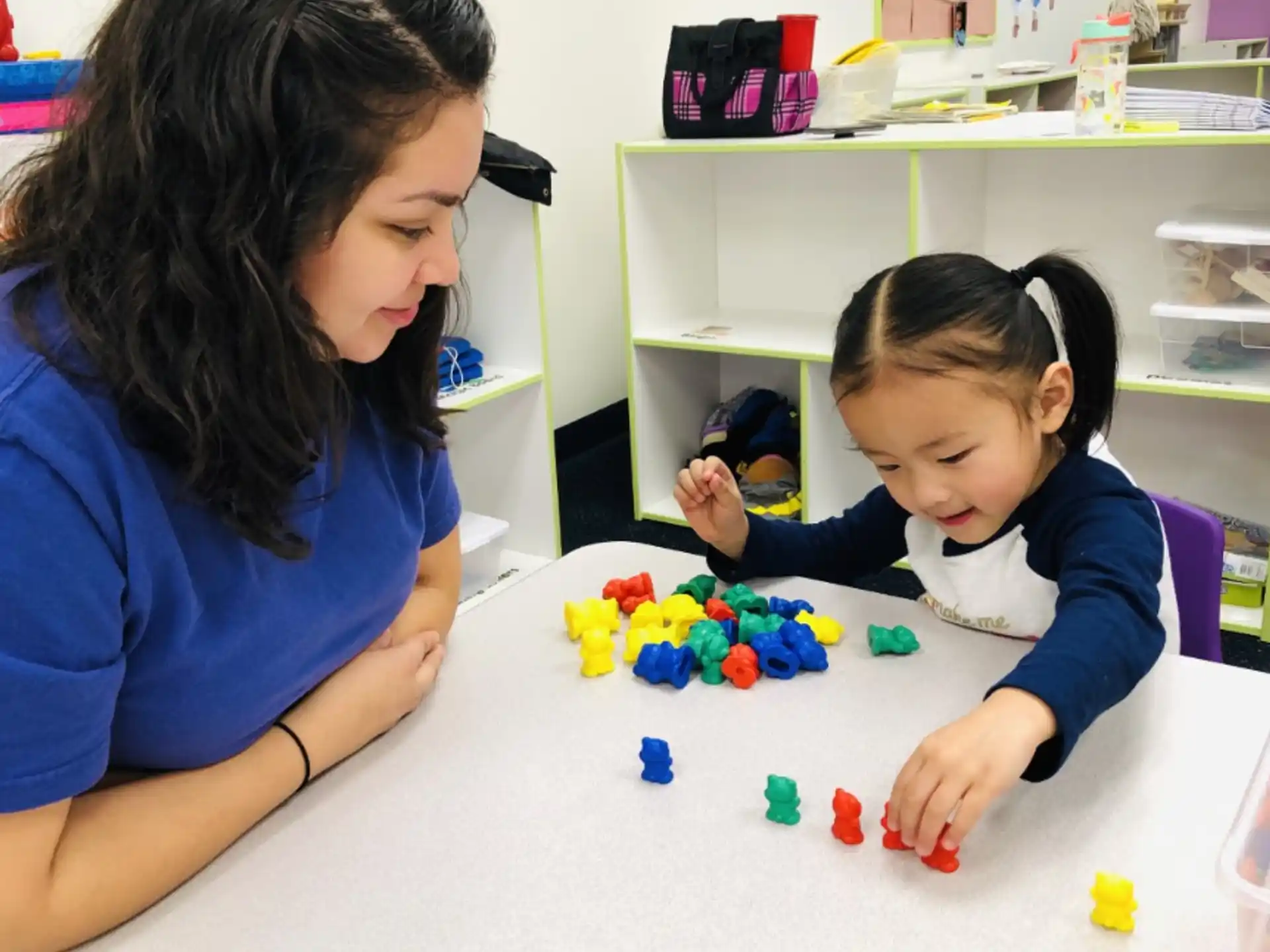 a person and a child playing with toys