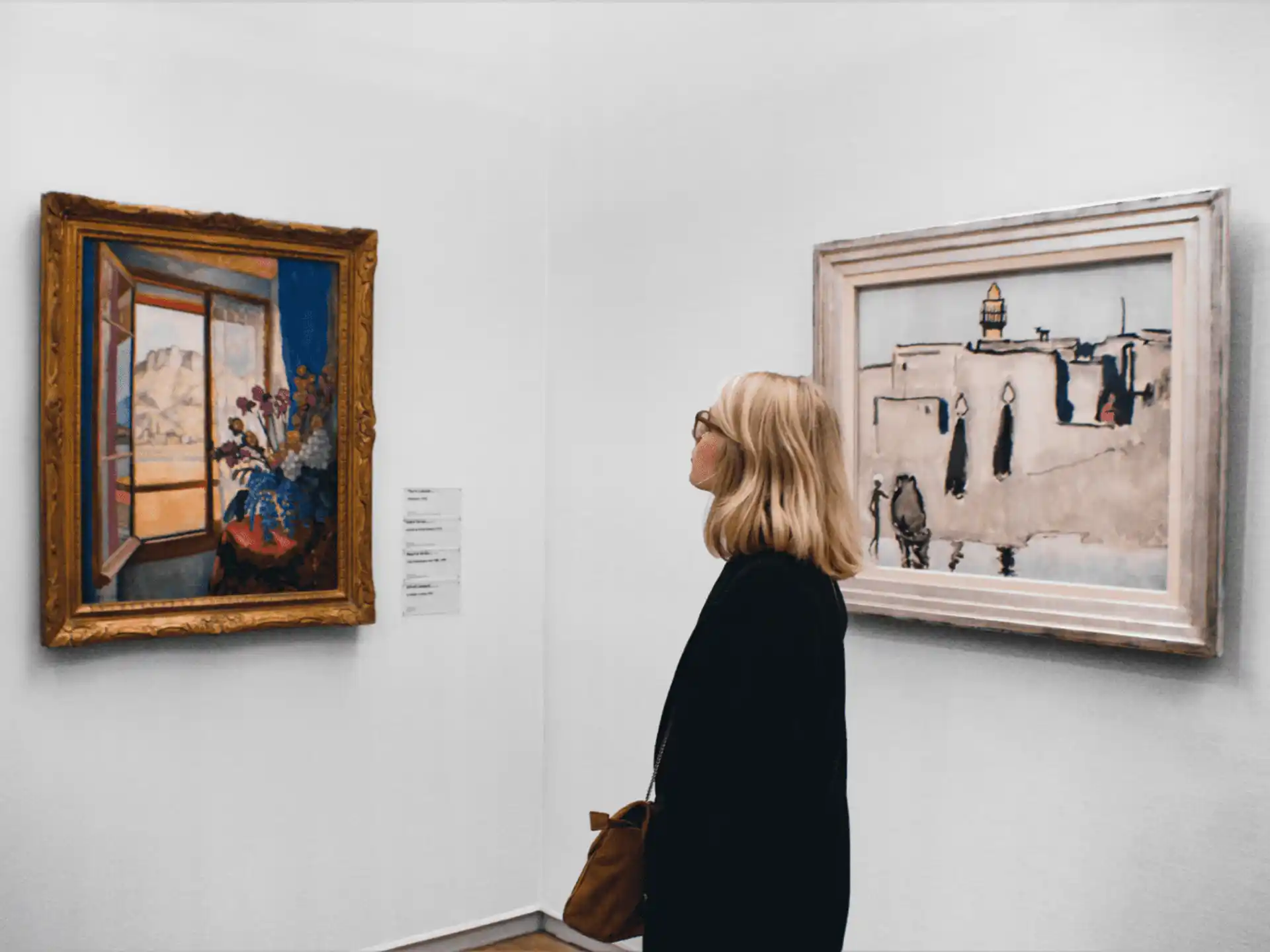 a person looking at art on a wall