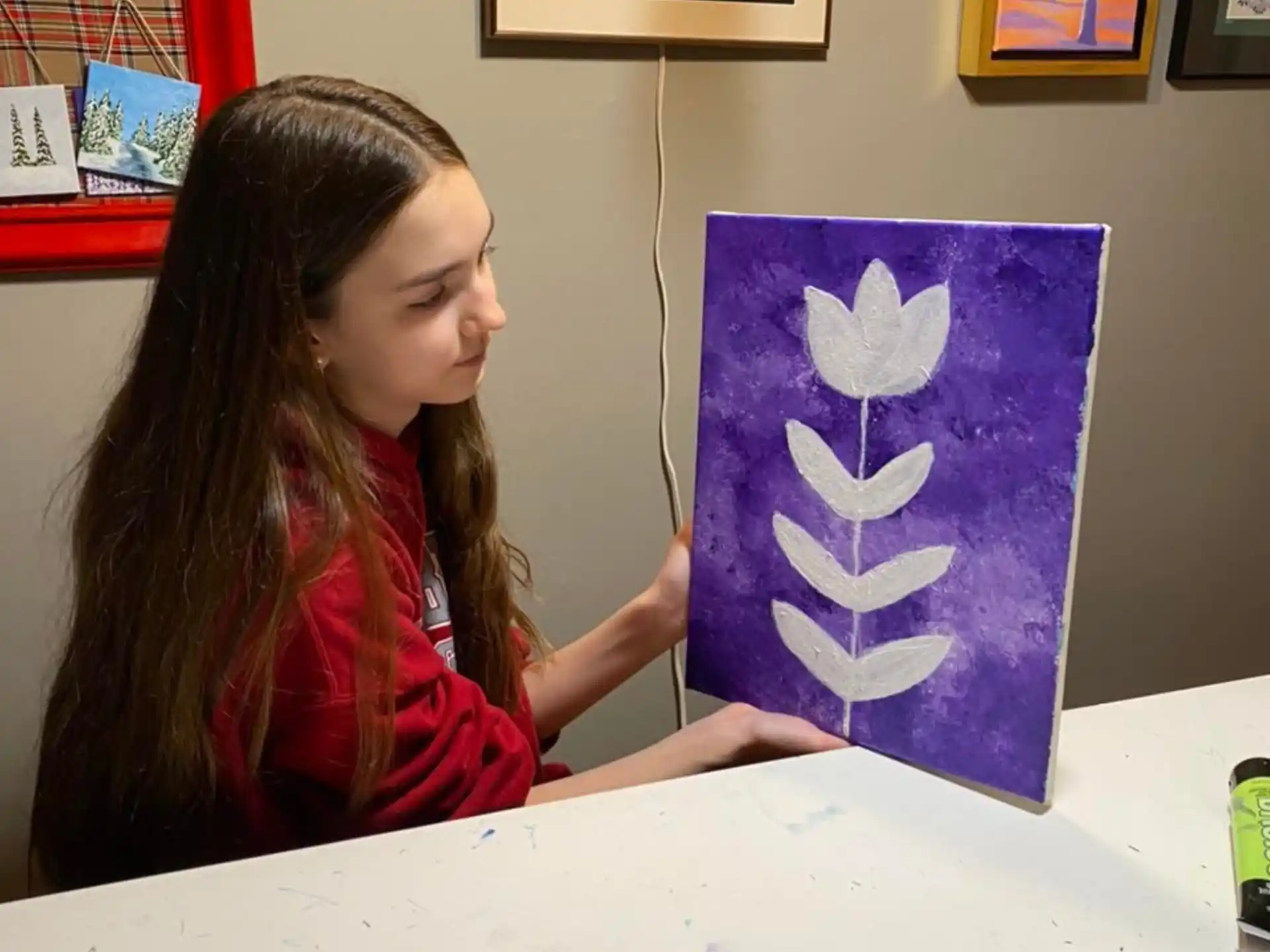 a girl drawing on a piece of paper