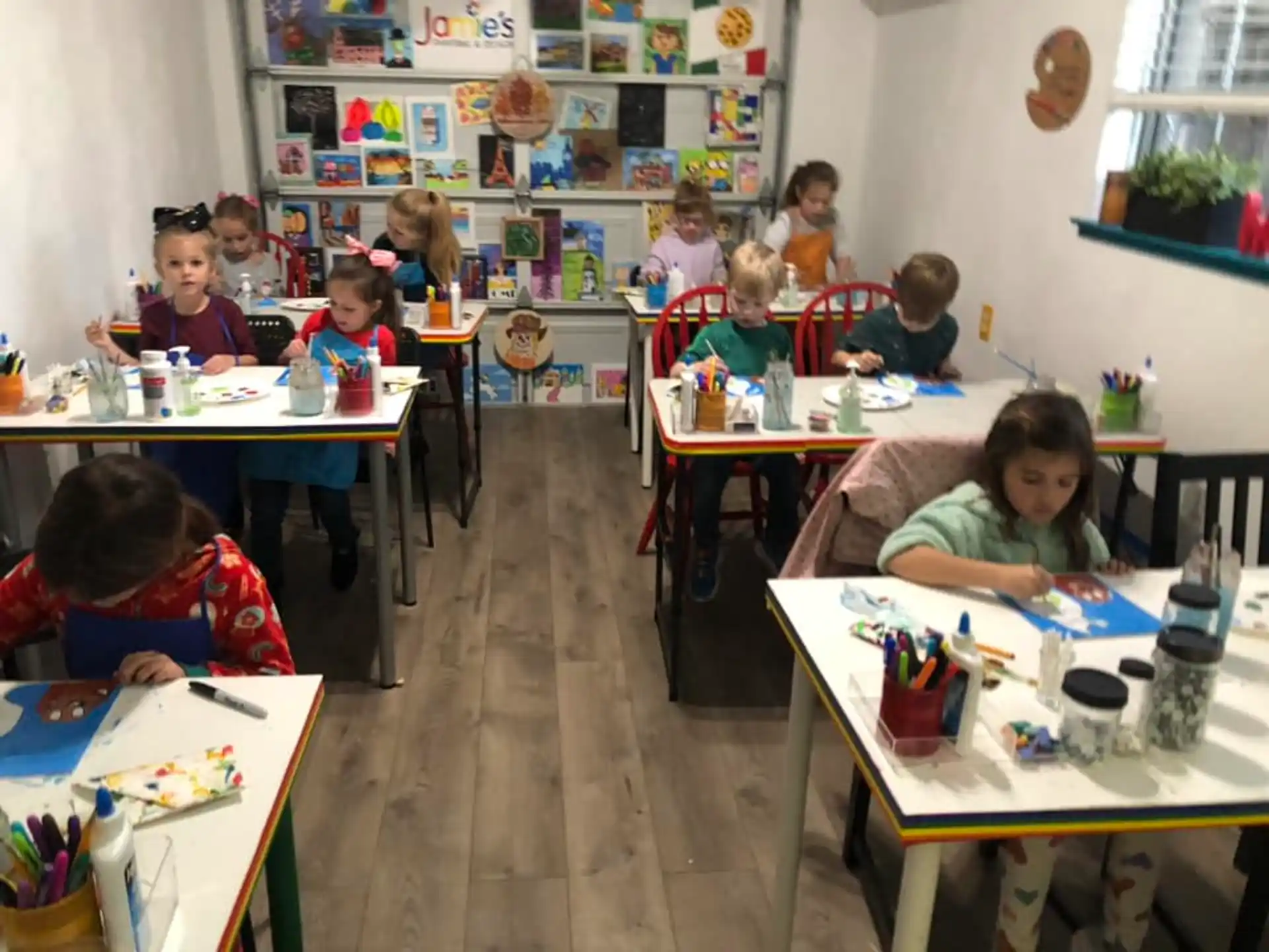 a group of children sitting at desks in a classroom