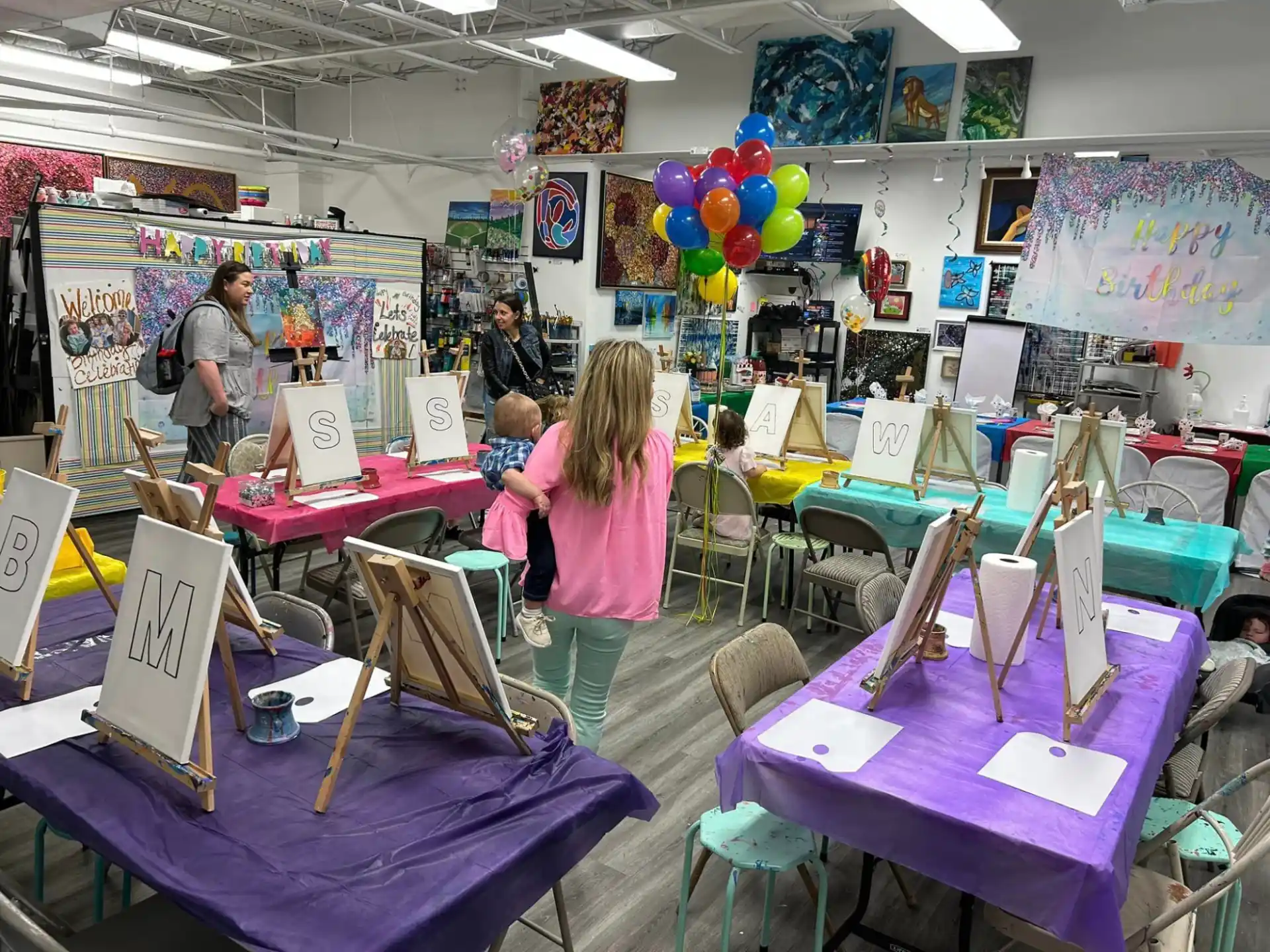 a group of people in a room with tables and chairs