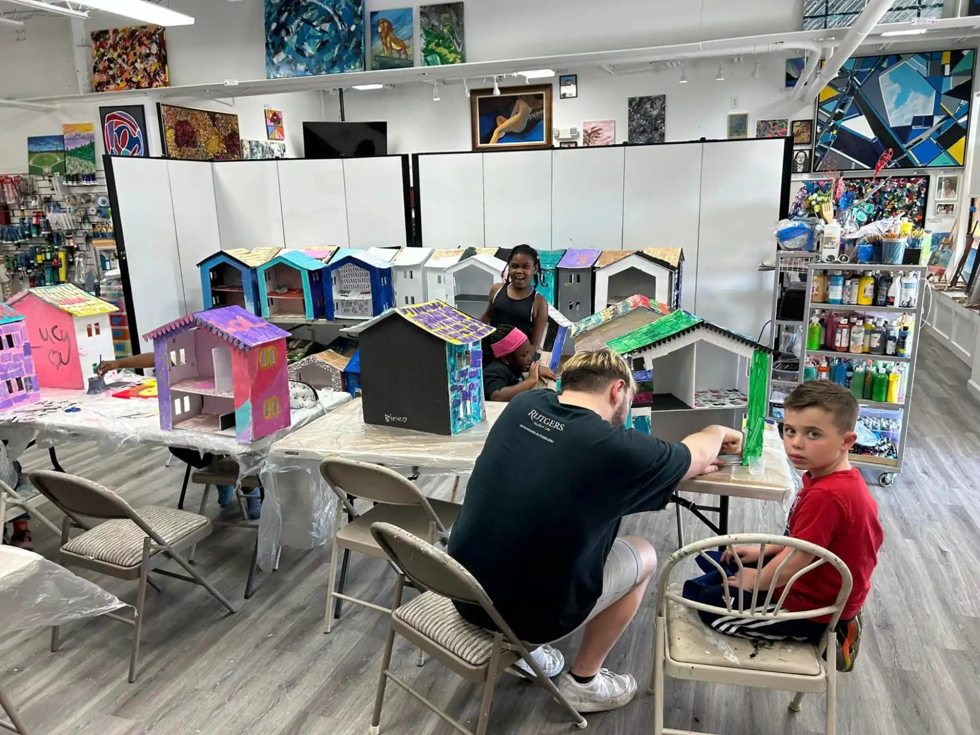 a group of people sitting at a table with computers