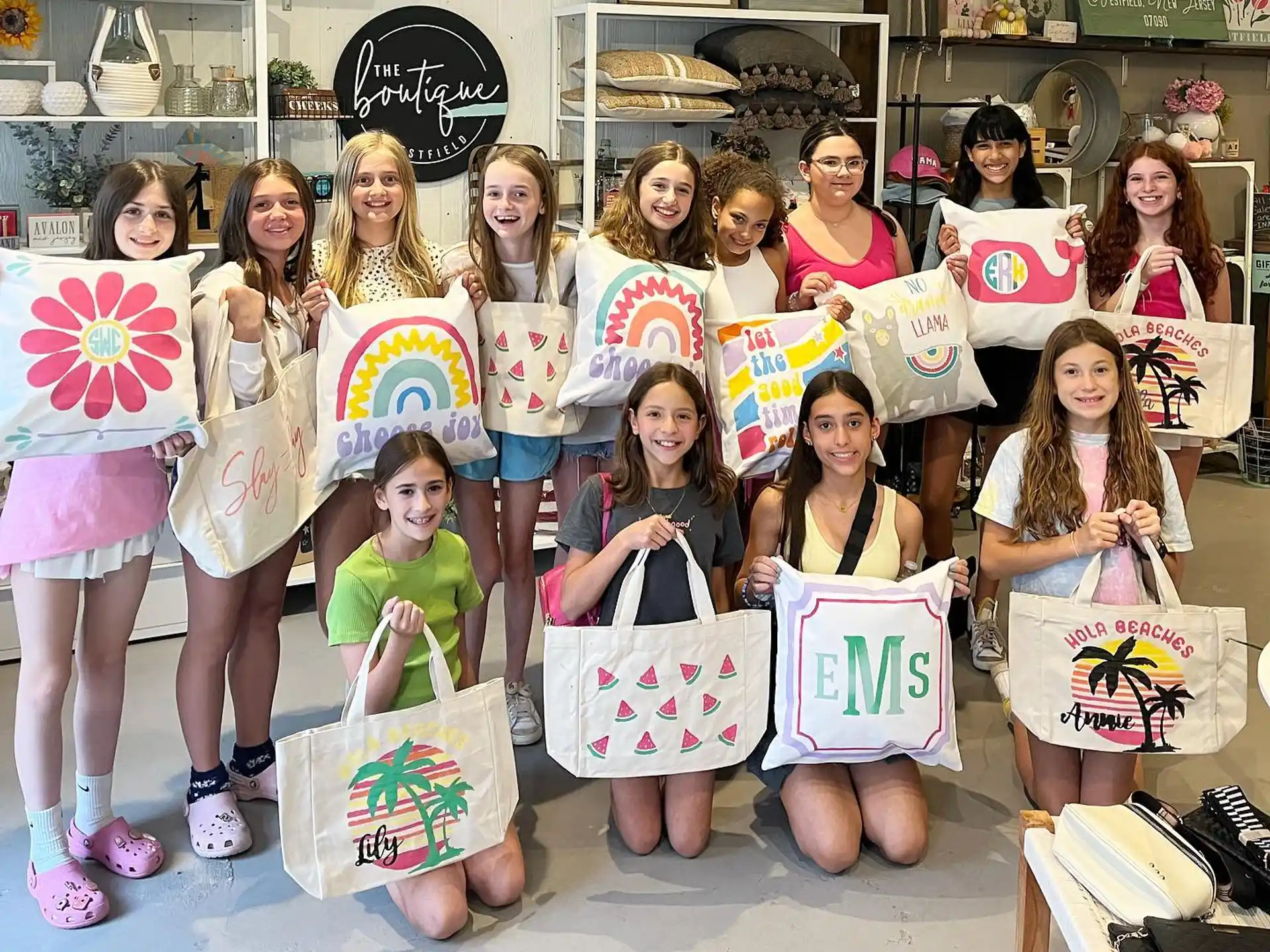 a group of girls holding bags