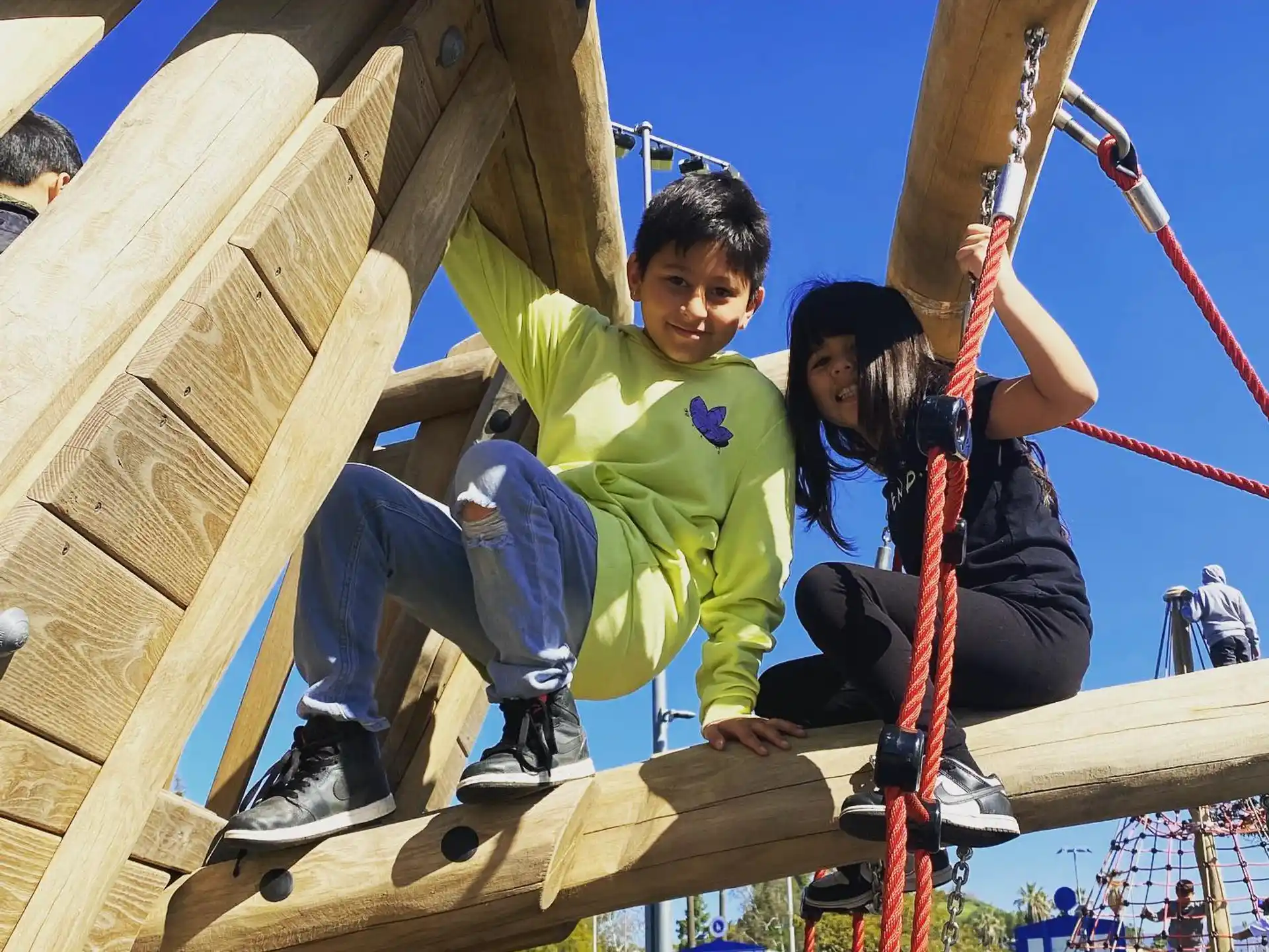 a boy and girl on a swing
