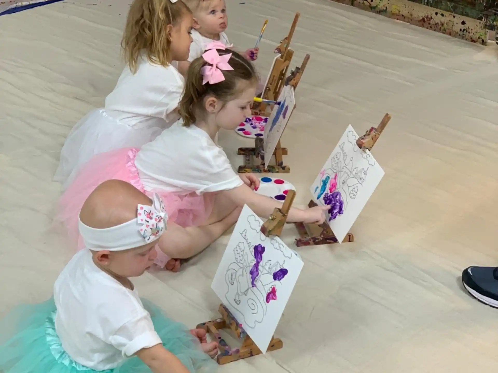 a group of girls sitting on the ground