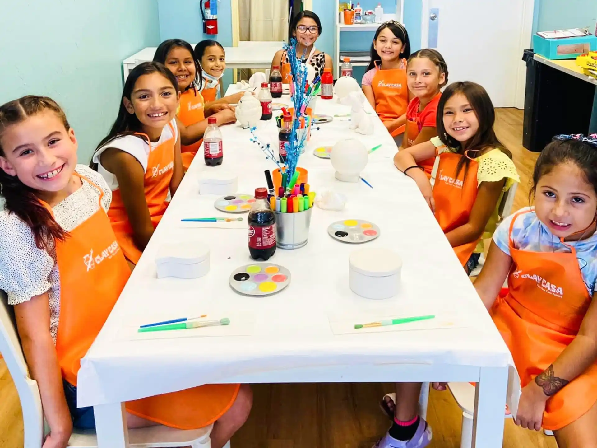 a group of children sitting around a table