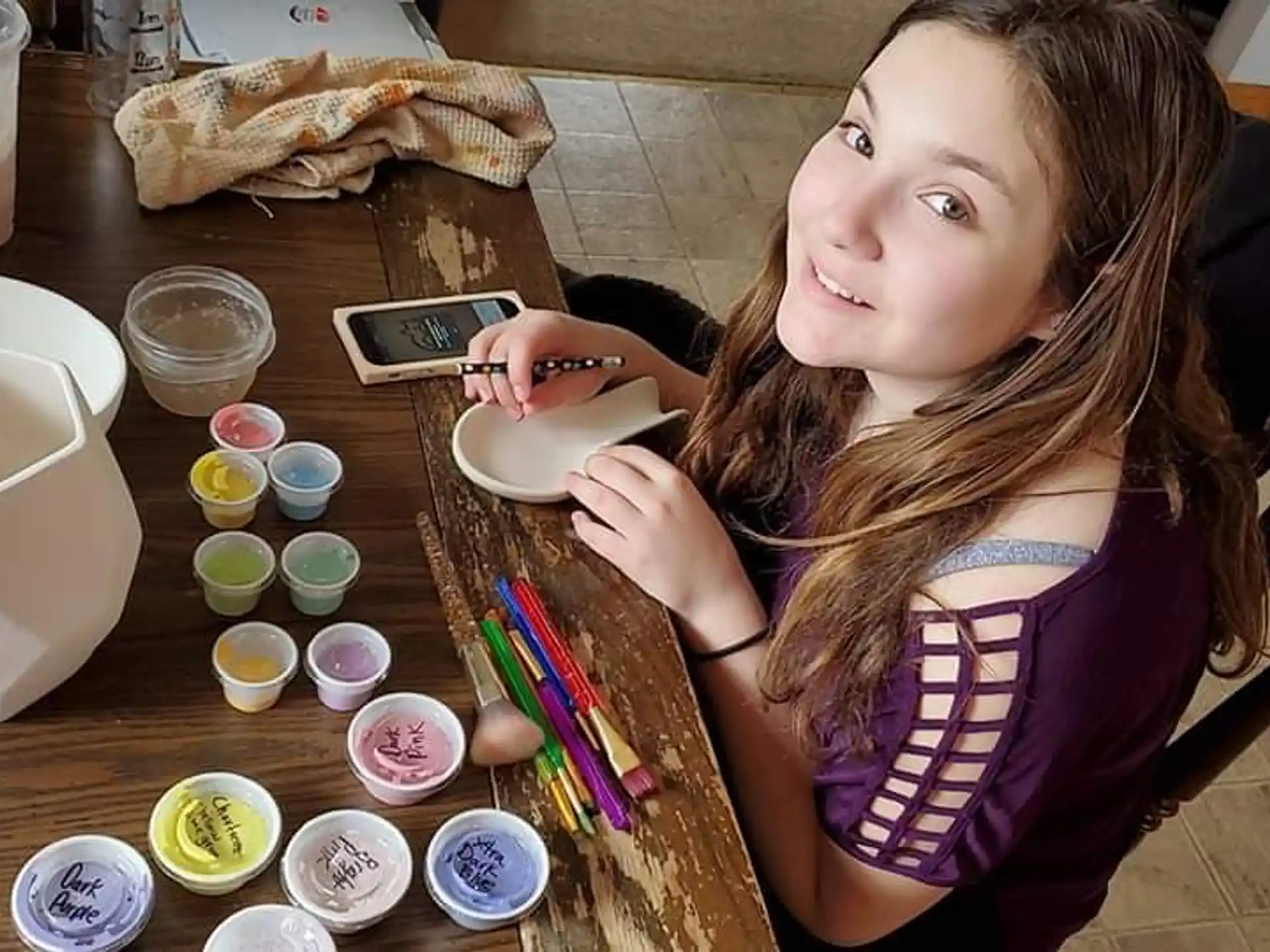 a person sitting at a table with a plate of food and a drink