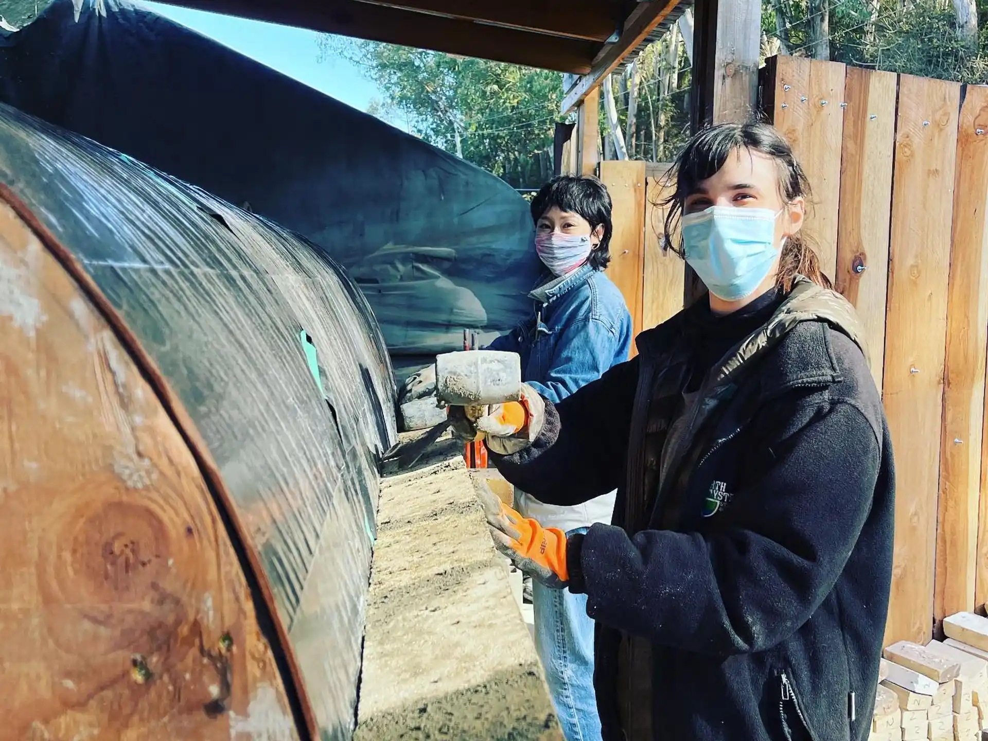 a person and a boy wearing face masks and holding a shovel