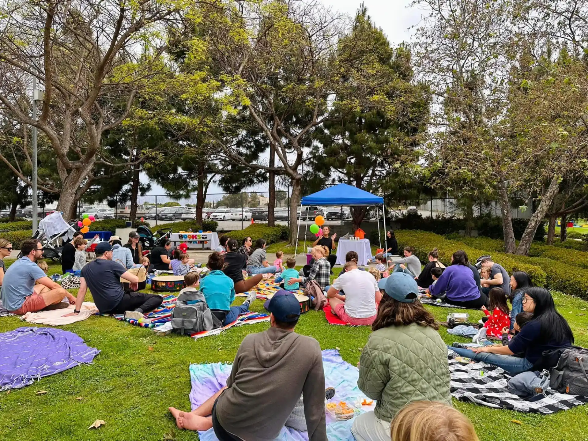 a group of people sitting on the grass