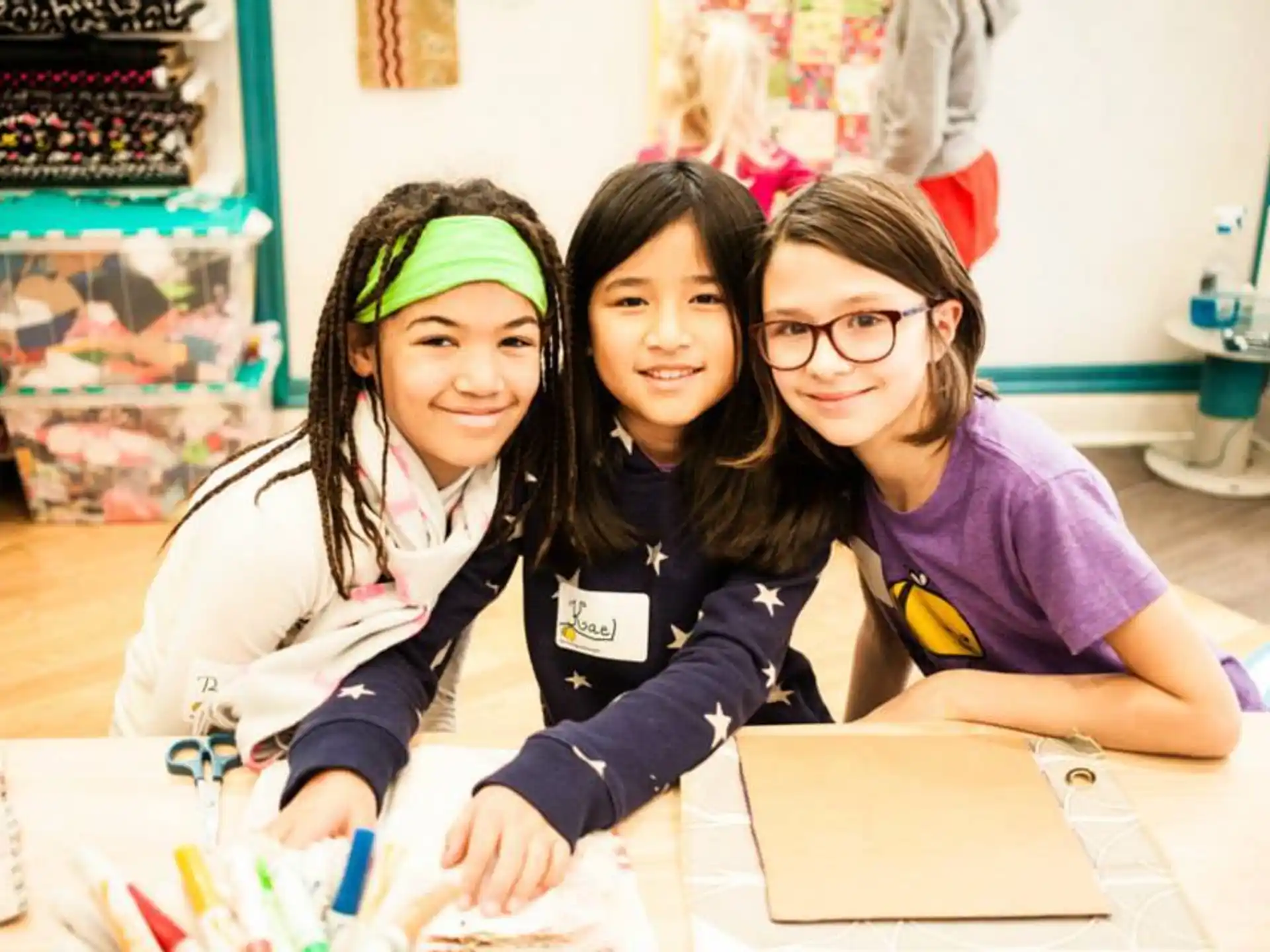 a group of girls sitting at a table