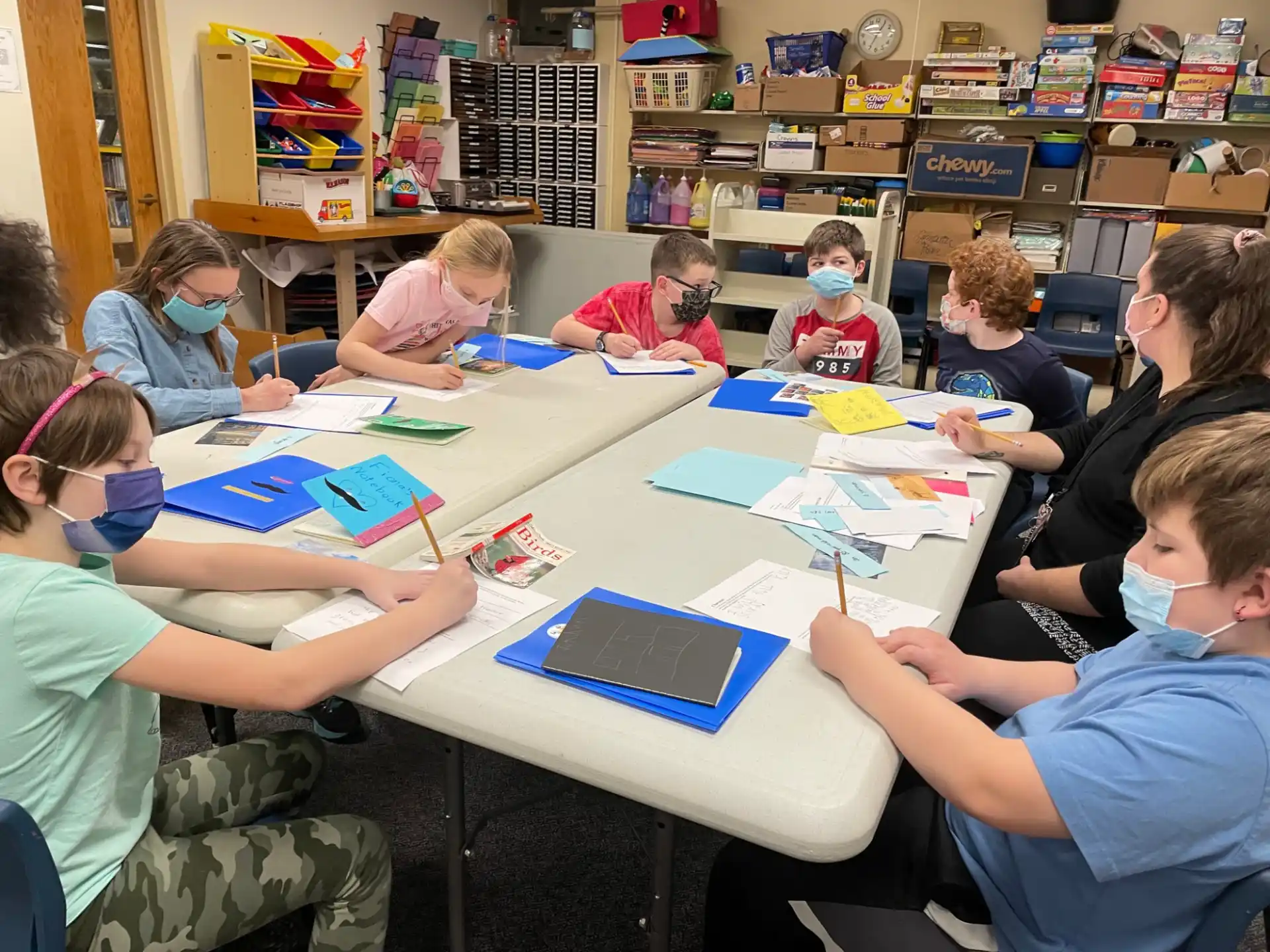 a group of children sitting at a table