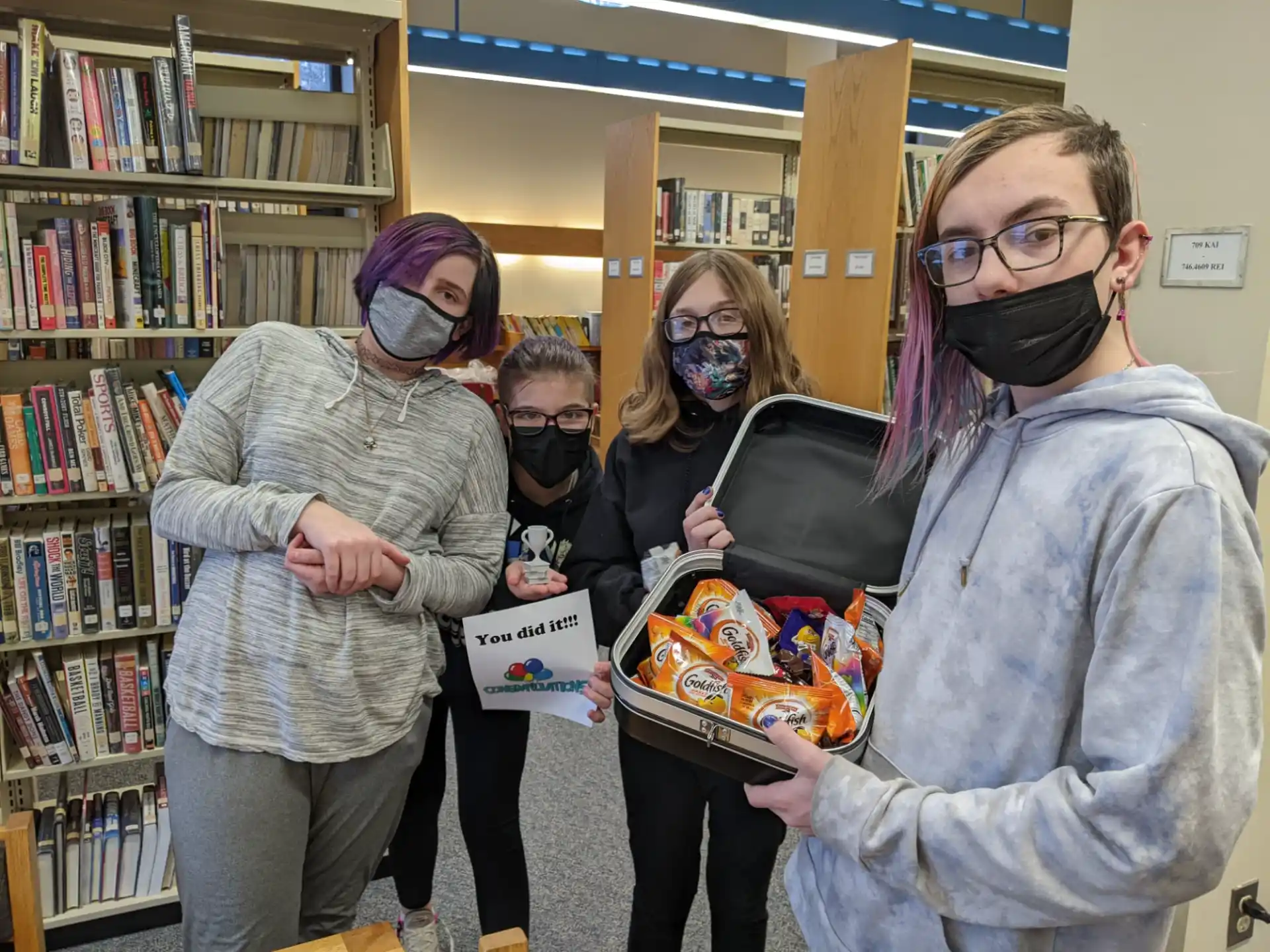 a group of people holding a box