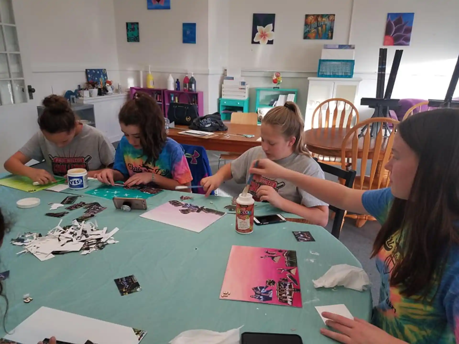 a group of children sitting around a table playing a board game